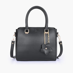 Black handbag with flower charm