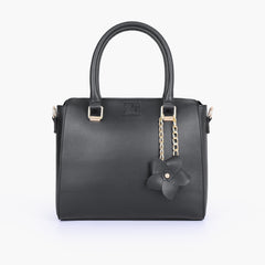 Black handbag with flower charm