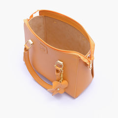 Mustard handbag with flower charm