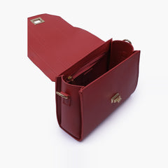 Maroon compact top-handle cross-body bag