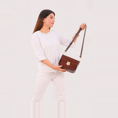 Dark brown suede saddle bag with twist lock