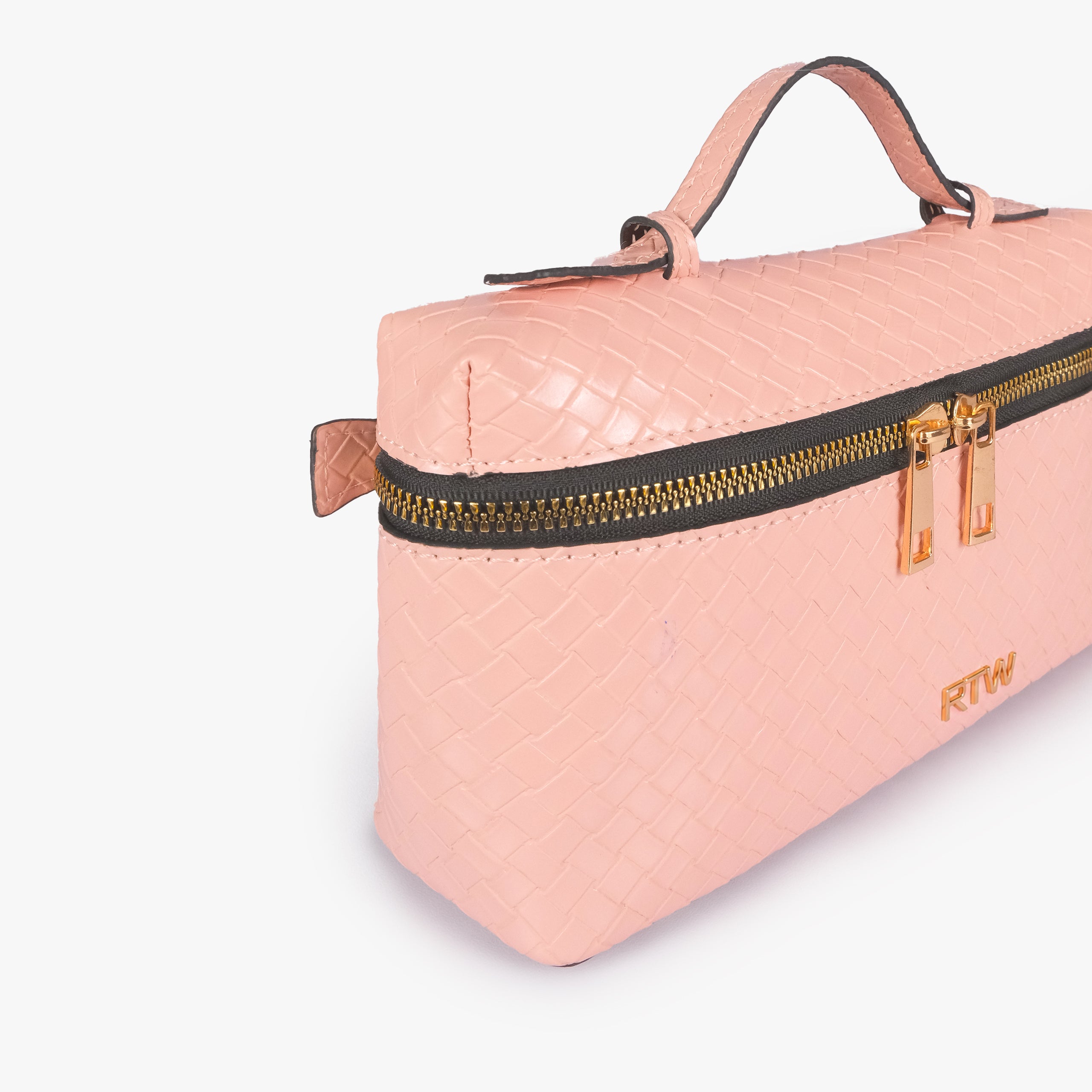 Peach weave vanity top-handle bag — closeup of the diamond-quilted faux-leather finish, stitching, dark zipper tape, gold-tone zipper pulls, and small front hardware mark