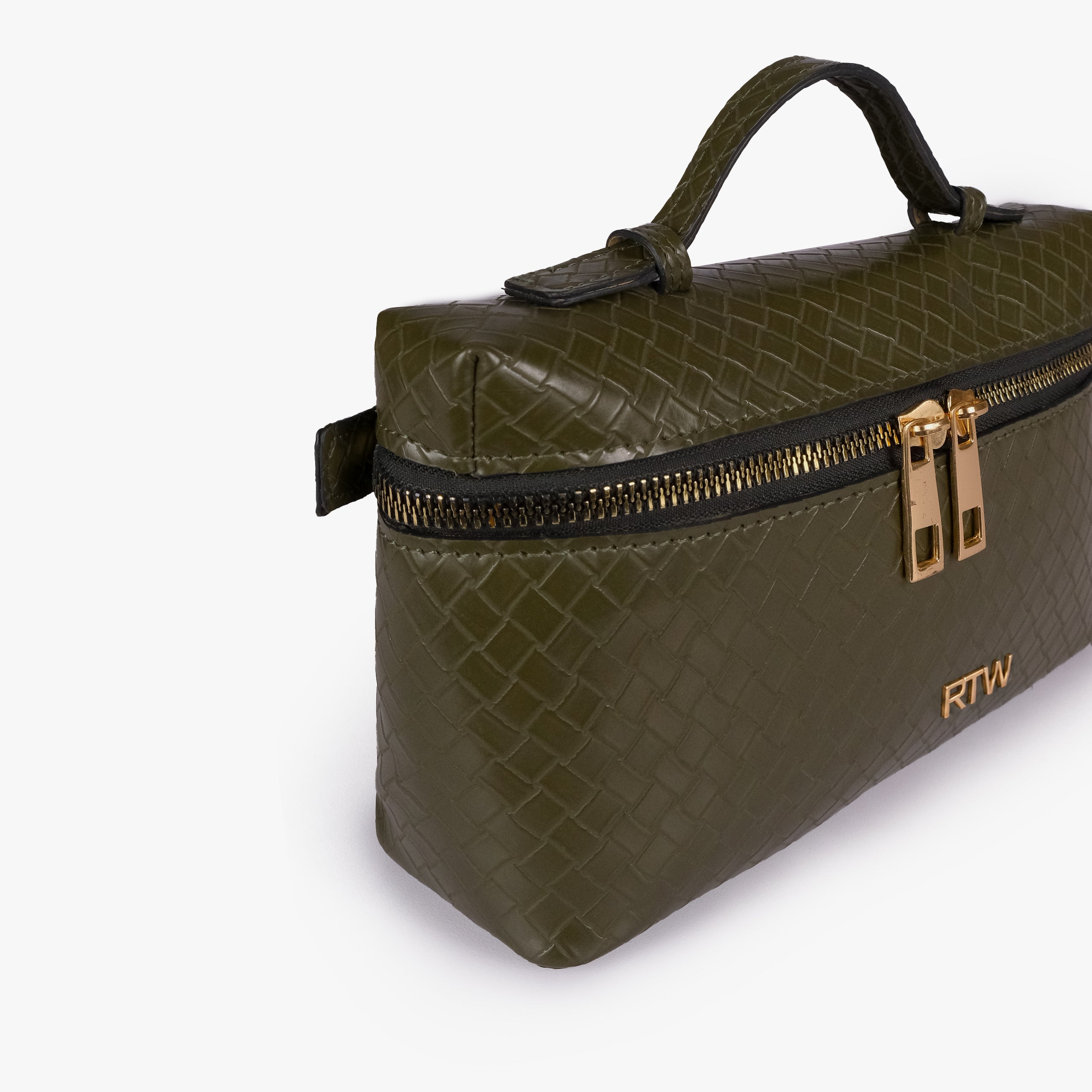 Olive green weave vanity top-handle bag — closeup of the diamond-quilted faux-leather finish, stitching, dark zipper tape, gold-tone zipper pulls, and small front hardware mark