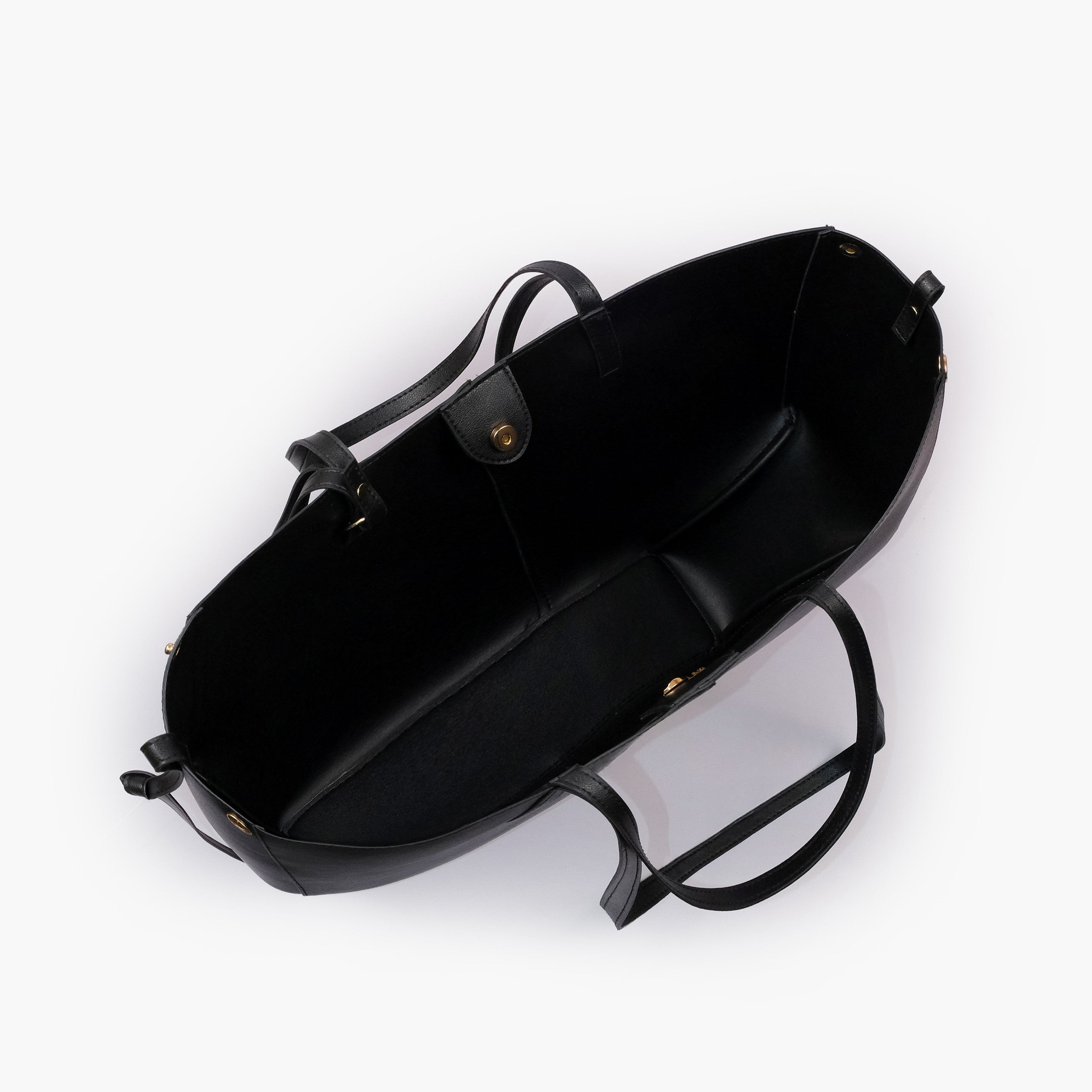 Black atelier tote — interior top-down view with smooth black faux leather lining, center divider panel, gold magnetic snap