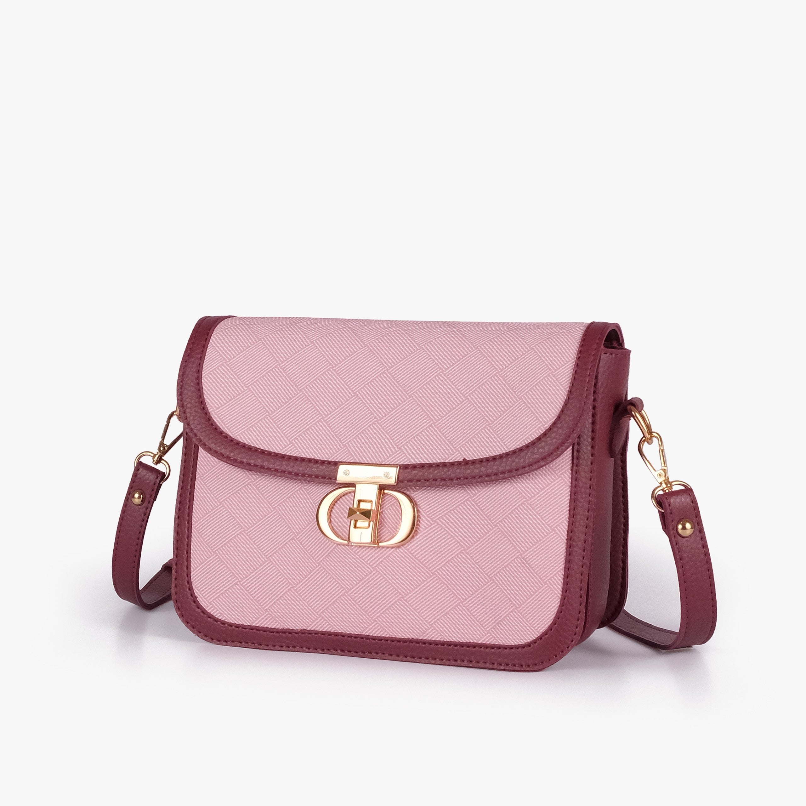 Pink contrast cross-body bag — hero 3/4 view, soft pink box-texture panel, deep burgundy pebbled trim, gold CD twist-lock rockstud and adjustable strap