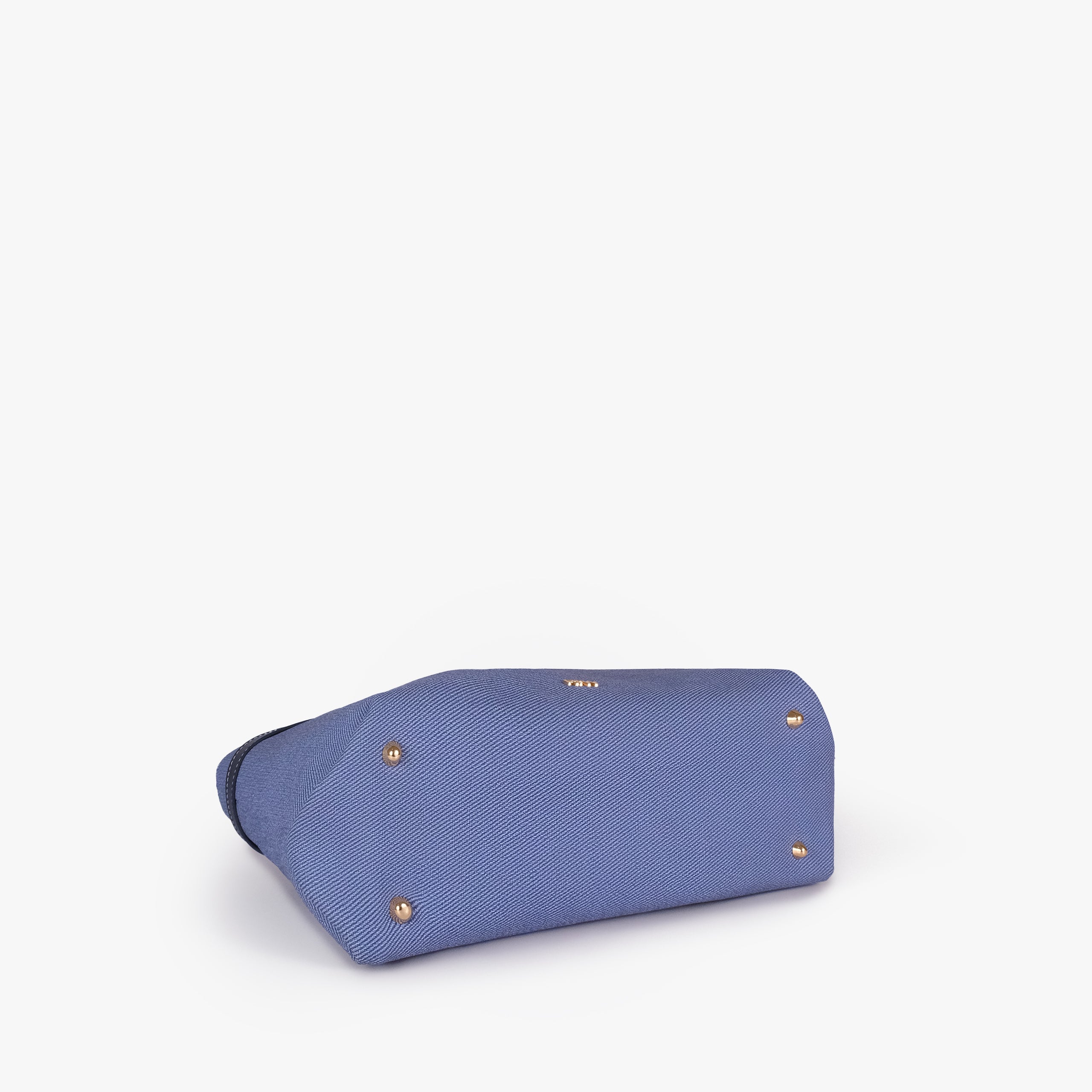 Navy belted tote bag — bottom view showing the structured base, smooth trim, and metal feet, blue-navy textured body with dark smooth faux-leather trim