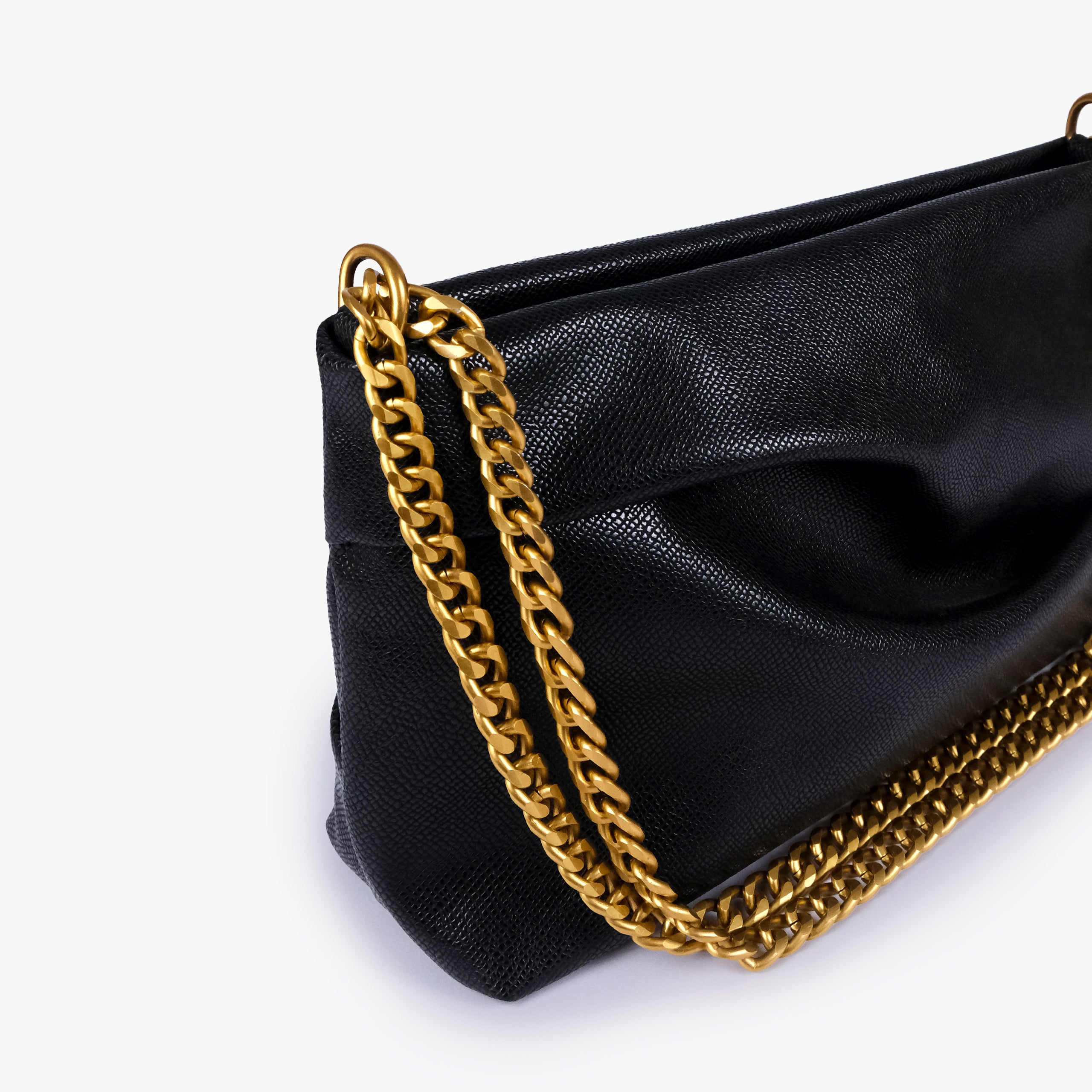Black pleated clutch bag with chain — close detail showing the pleated faux-leather surface, chain links and top-corner hardware, deep black