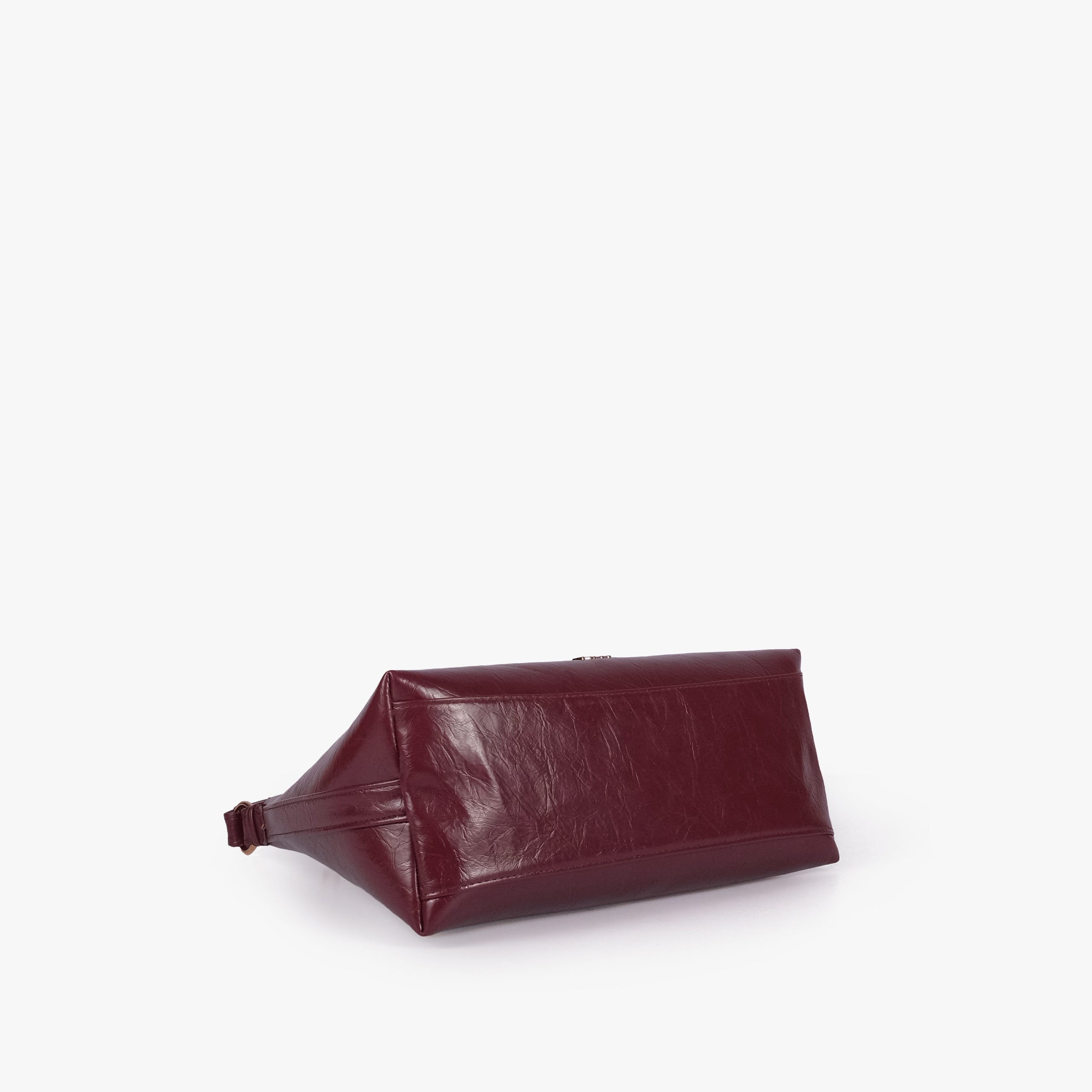 Maroon crinkle crescent hobo — base view showing the matching faux-leather bottom and softly structured shape
