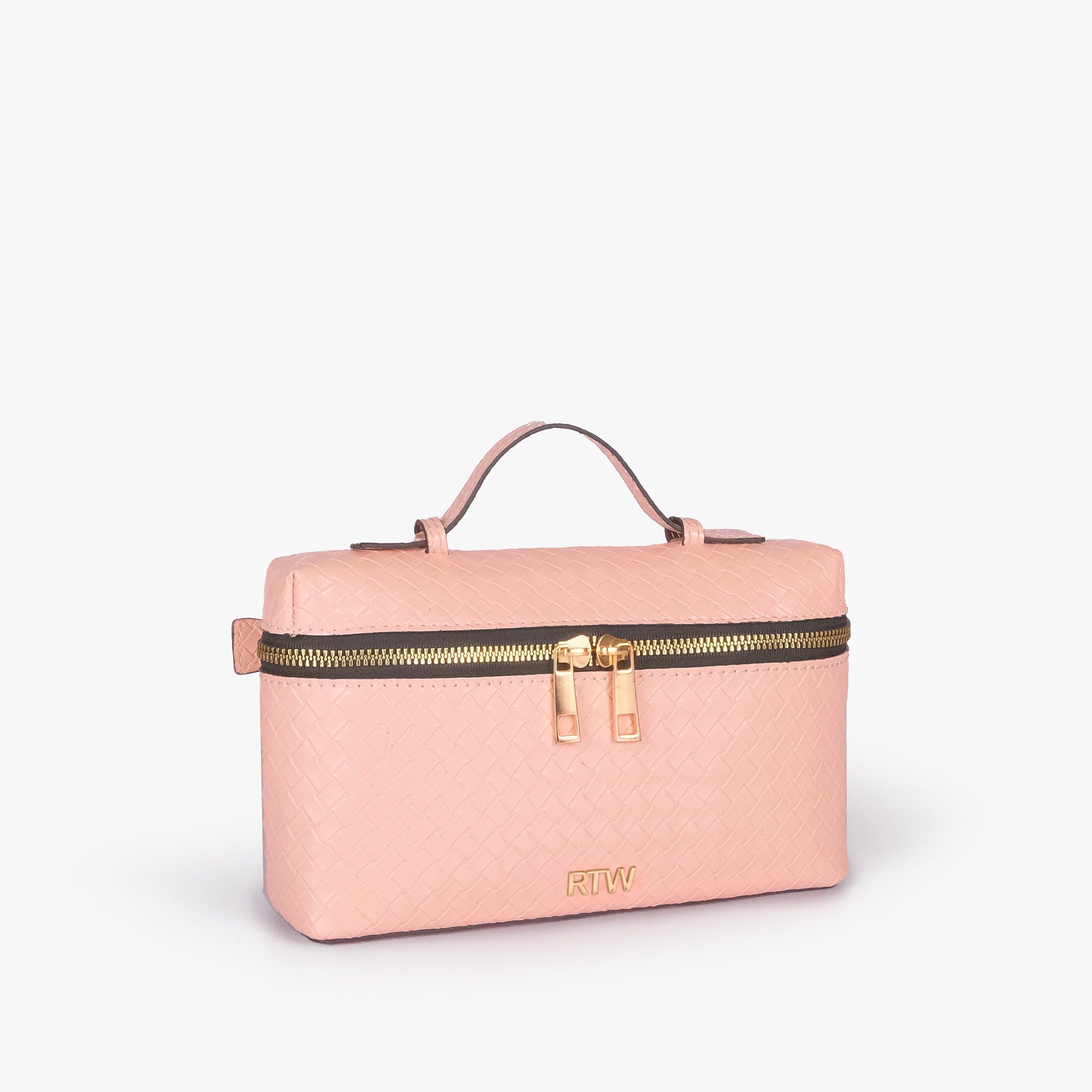 Peach weave vanity top-handle bag — 3/4 quarter view showing the compact boxy vanity shape, rounded edges, diamond quilting, strap attachment, and side depth