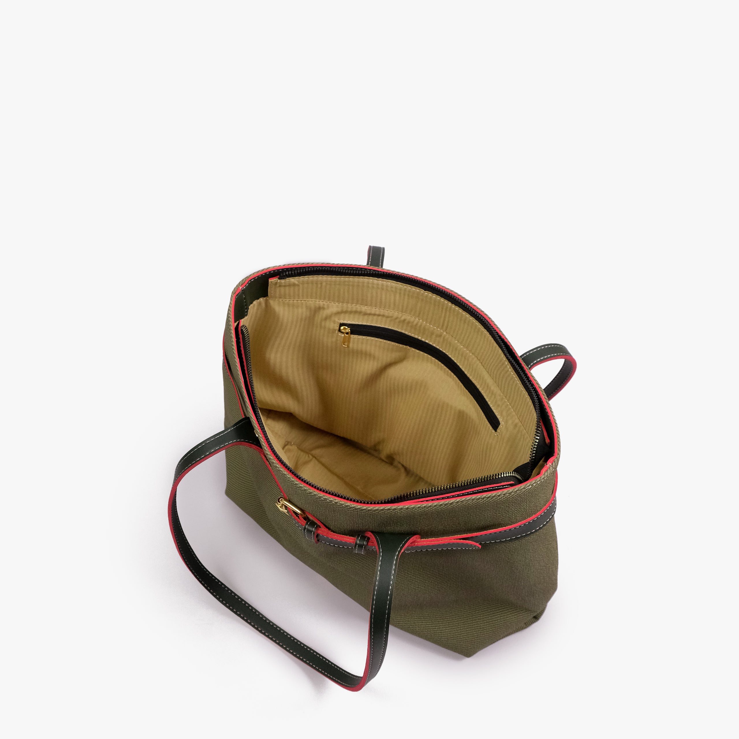 Olive belted tote bag — open-top interior view showing the tan interior, structured rim, long handles, and belted front detail, olive green textured body with dark smooth faux-leather trim with red accent edging