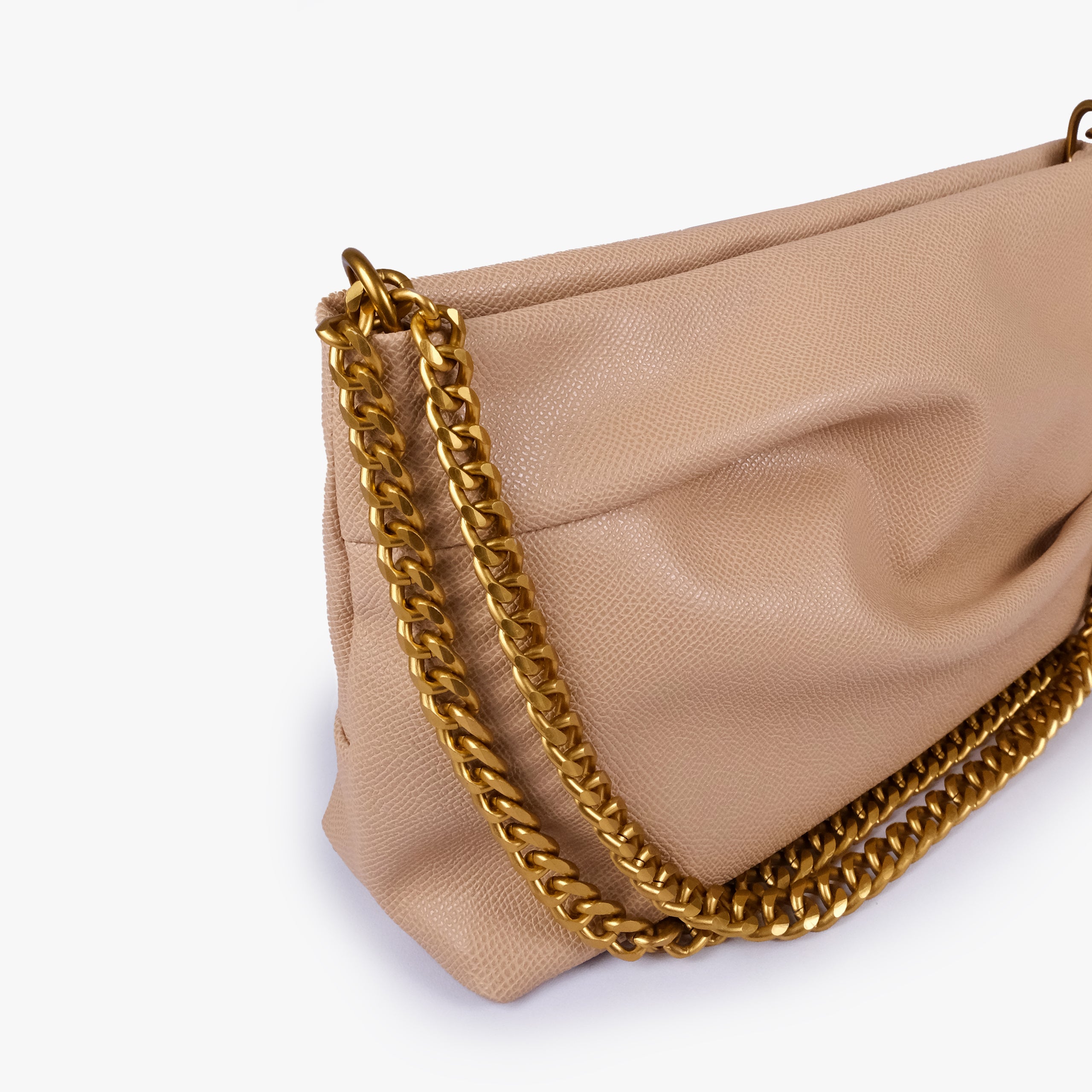 Beige pleated clutch bag with chain — close detail showing the pleated faux-leather surface, chain links and top-corner hardware, warm pale beige