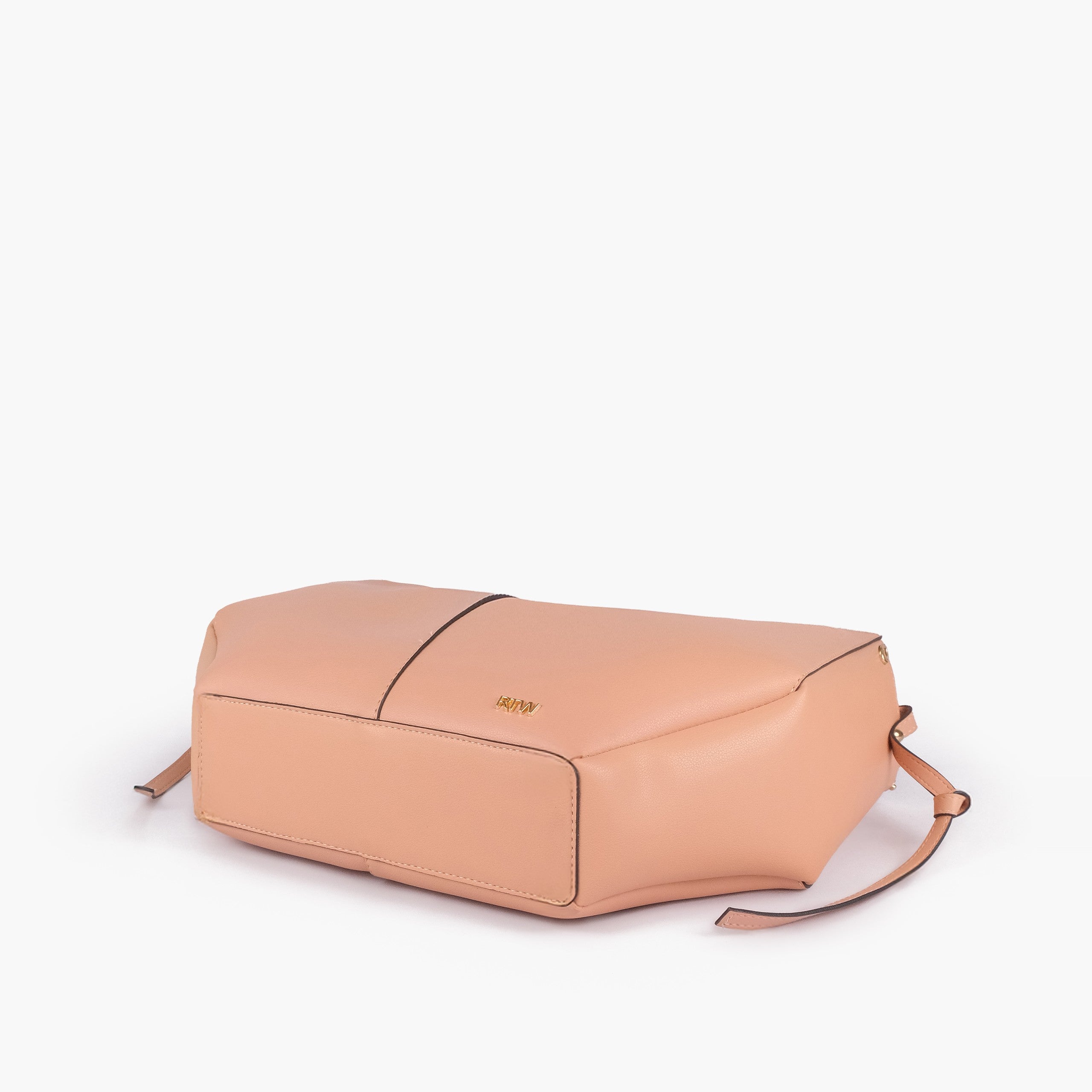 Peach atelier tote — base angle showing reinforced flat base, gold RTW logo on front-bottom face