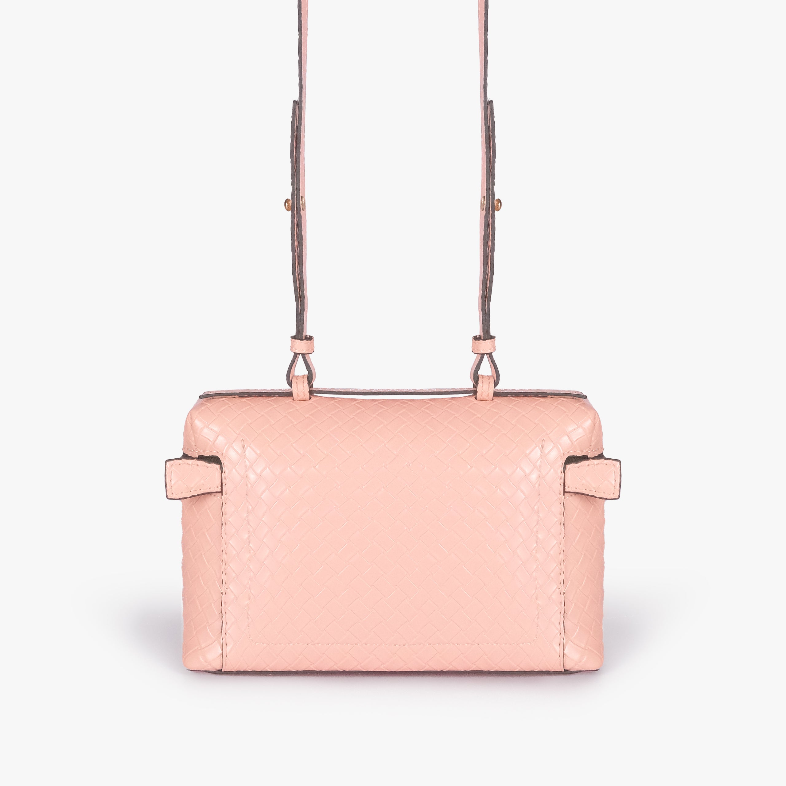 Peach weave vanity top-handle bag — back view showing the plain quilted back panel, top handle, long strap, flat base line, and no visible exterior pocket