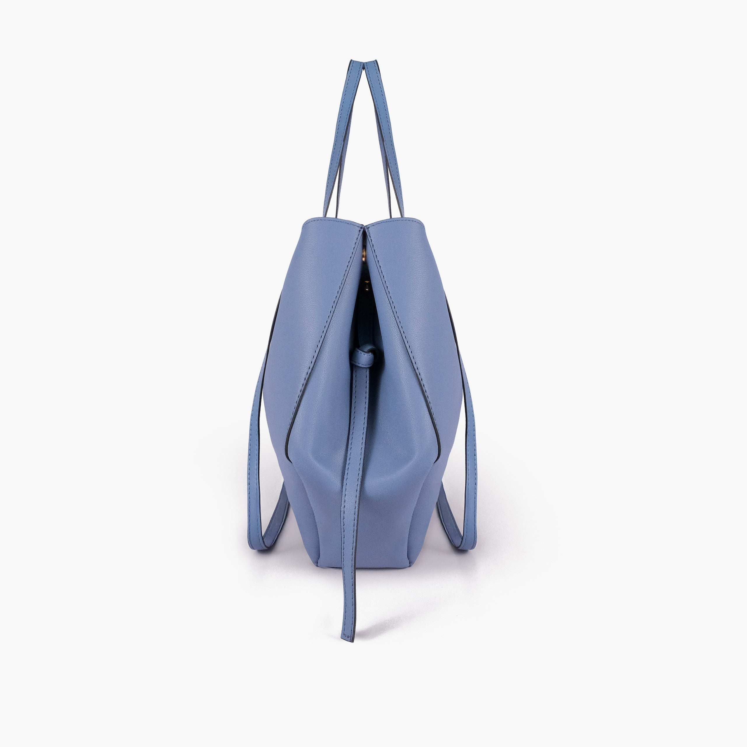 Sky blue atelier tote — side profile showing wing-cut origami fold, cinch tie, and slim shoulder handle