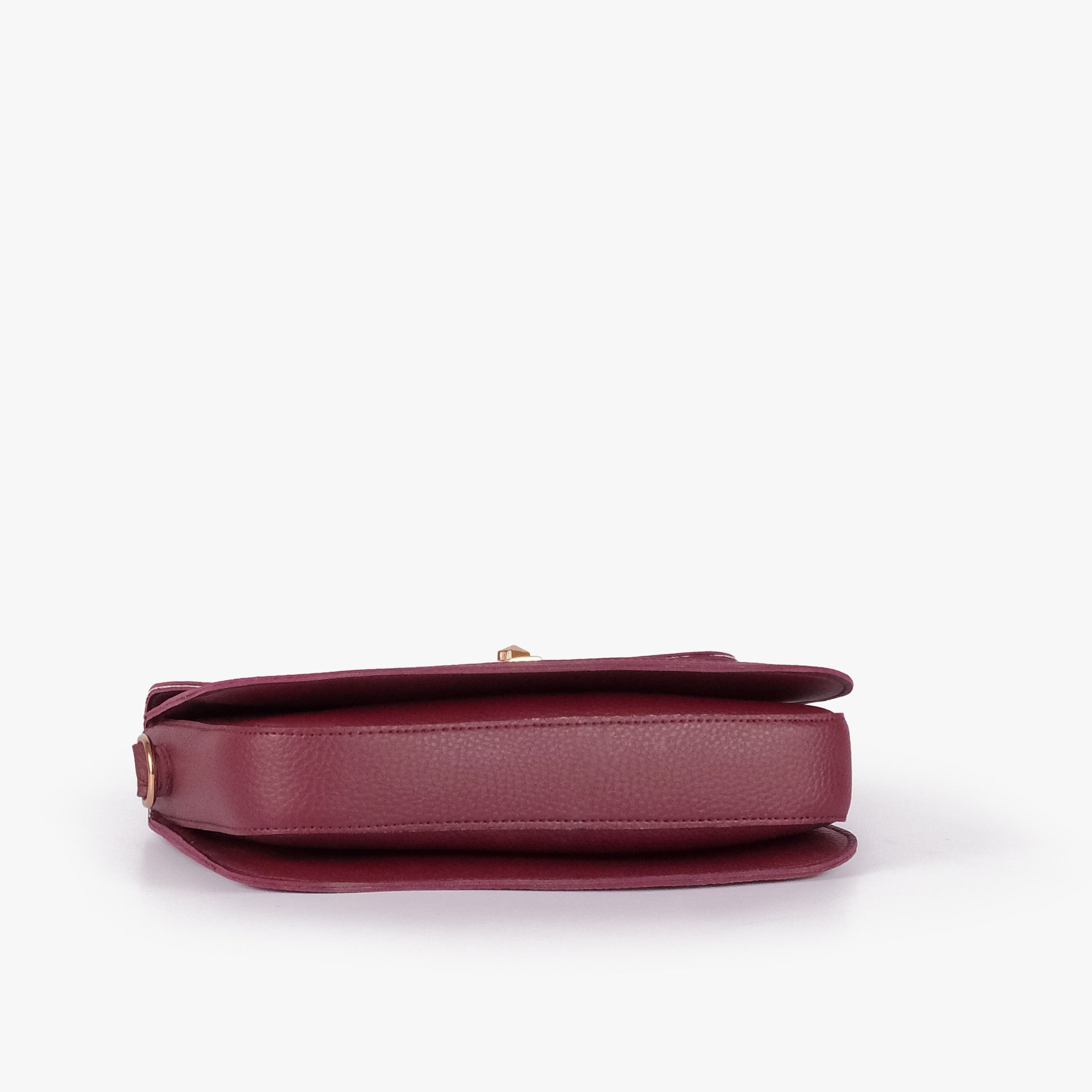 Pink contrast cross-body bag — tilted underside flat lay showing flap edge and bag depth