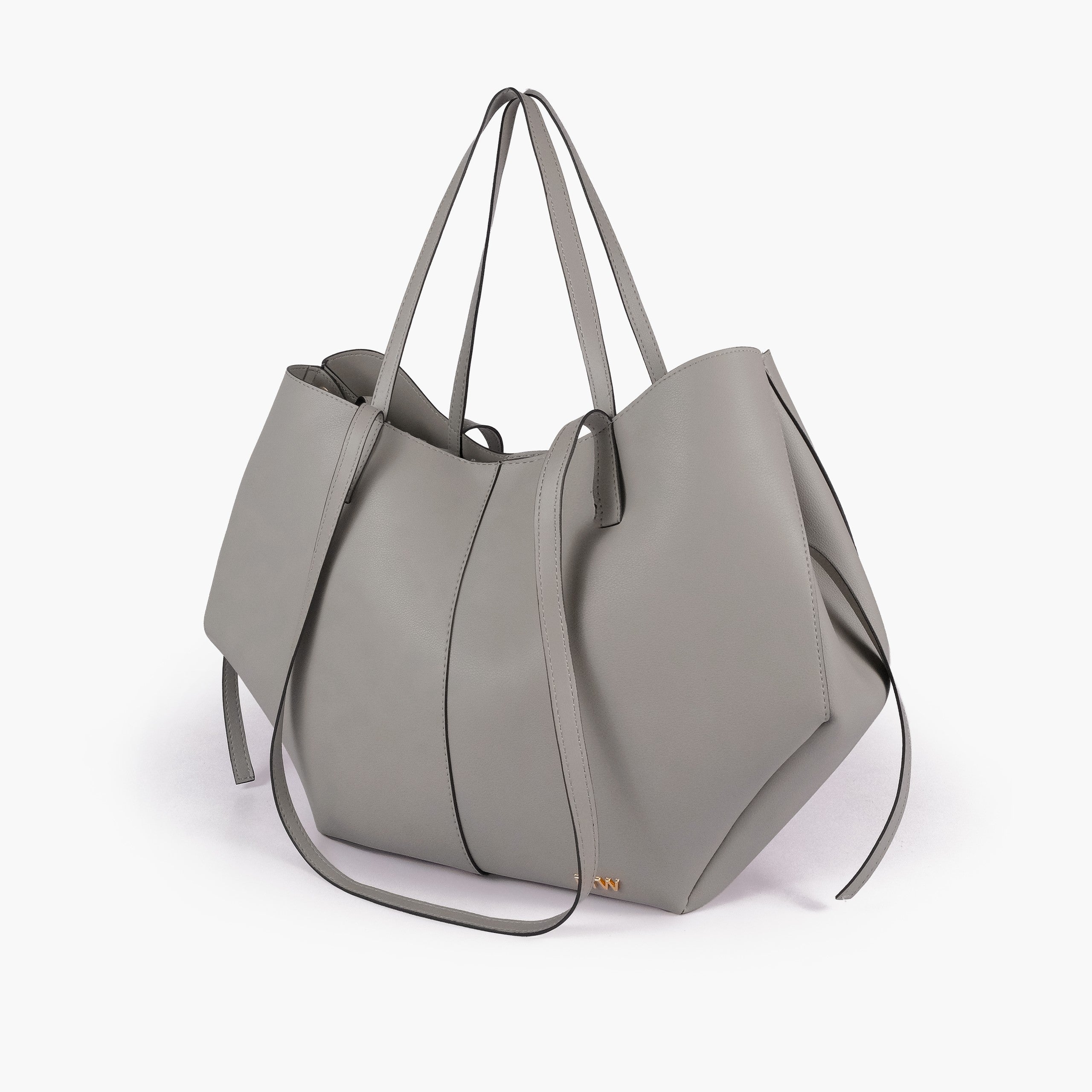 Grey atelier tote — hero 3/4 quarter view, soft cool grey smooth faux leather, wing-cut origami side panels, slim handles, gold RTW logo at front base