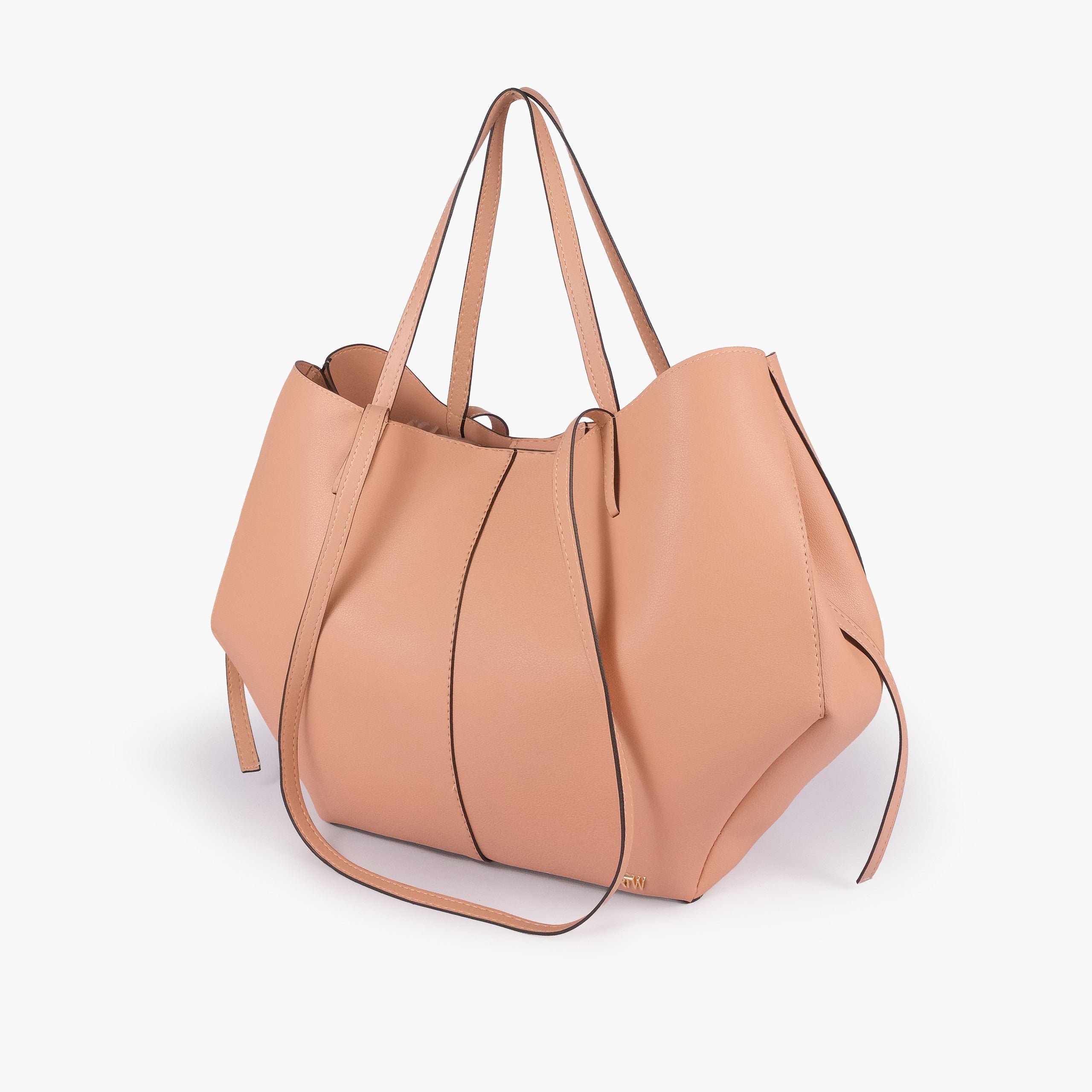 Peach atelier tote — hero 3/4 quarter view, muted blush peach smooth faux leather, wing-cut origami side panels, slim handles, gold RTW logo at front base
