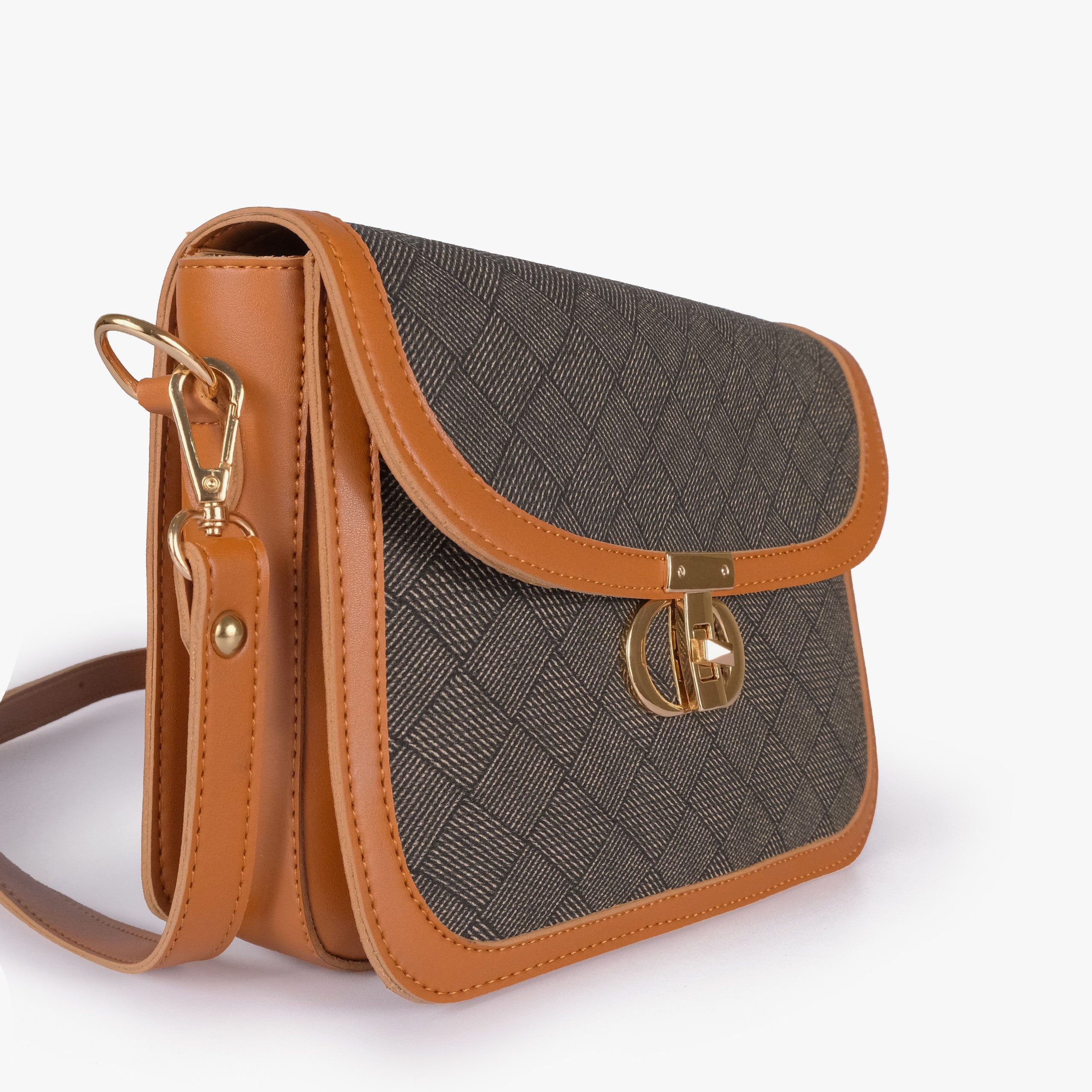 Camel contrast cross-body bag — closeup of dark olive crosshatch panel, camel pebbled trim border, and gold twist-lock rockstud
