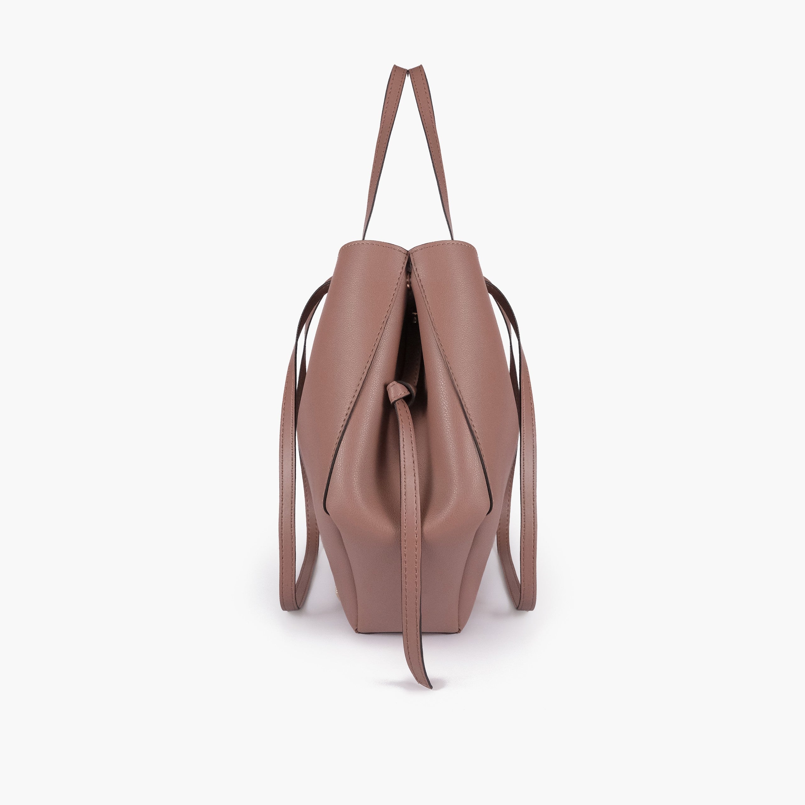 Brown atelier tote — side profile showing wing-cut origami fold, cinch tie, and slim shoulder handle