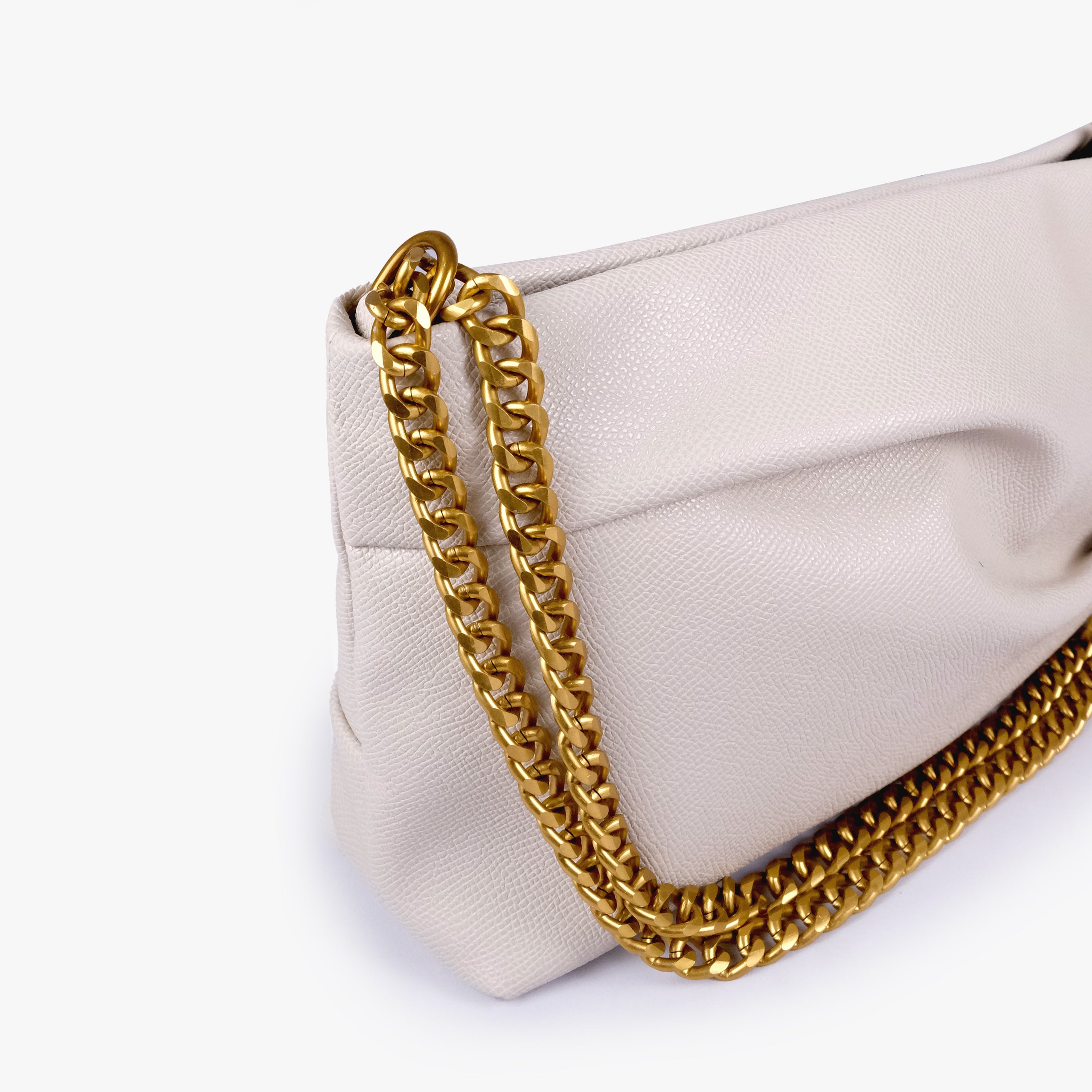 Cream pleated clutch bag with chain — close detail showing the pleated faux-leather surface, chain links and top-corner hardware, soft ivory cream