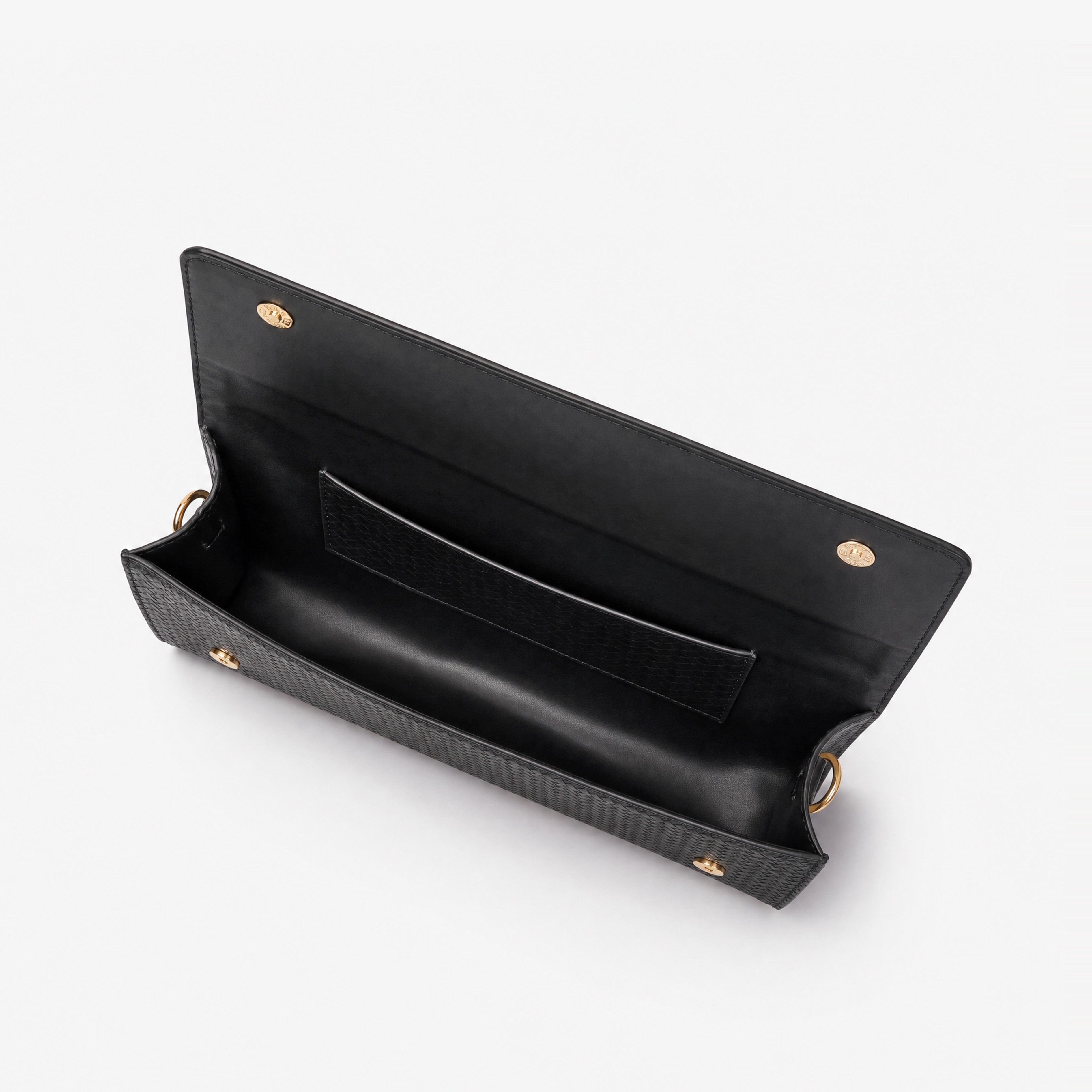 Woven black weave clutch — interior open view with smooth black faux leather lining and woven-pattern slip pocket