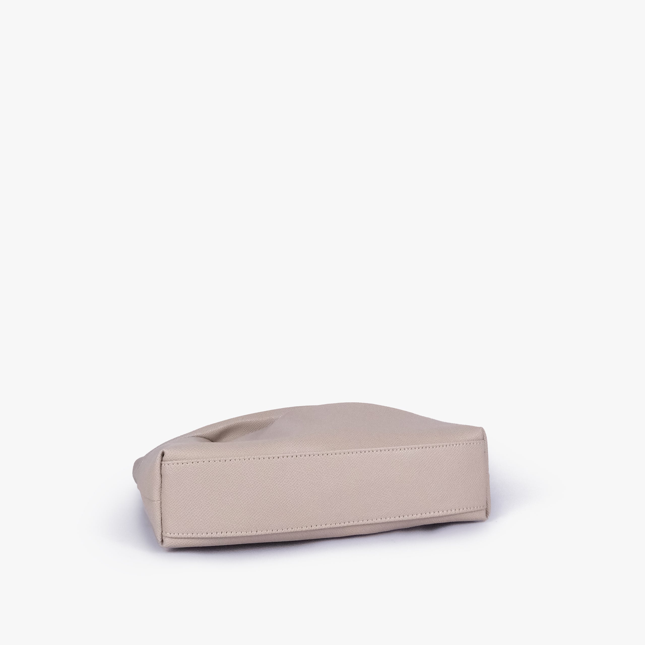 Taupe pleated clutch bag with chain — bottom view showing the stitched flat base and slim depth, pale gray-beige taupe