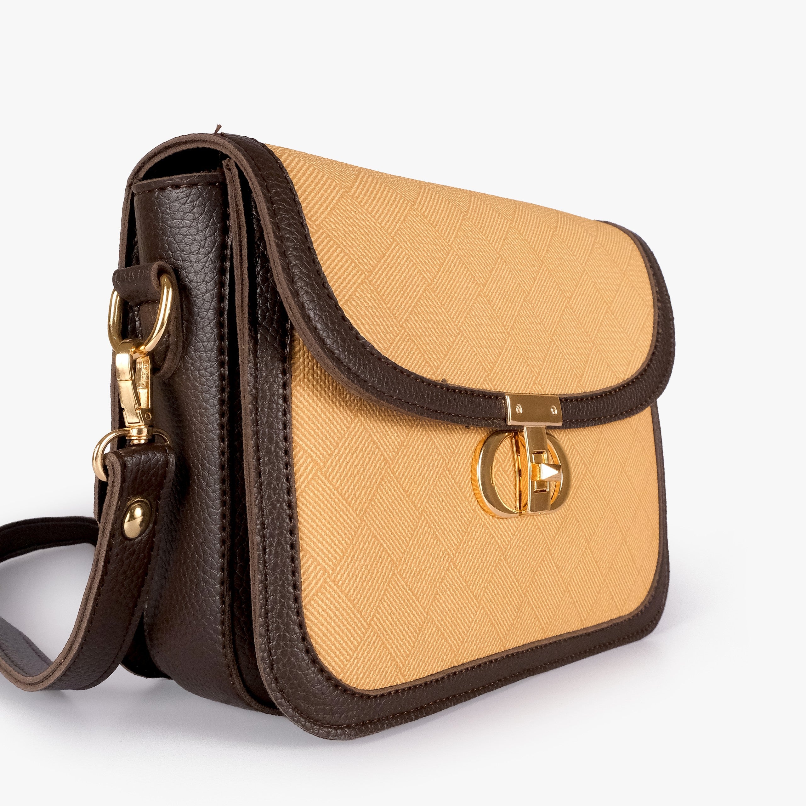 Beige contrast cross-body bag — closeup of amber-gold crosshatch box-texture panel, deep espresso pebbled trim, and gold twist-lock rockstud