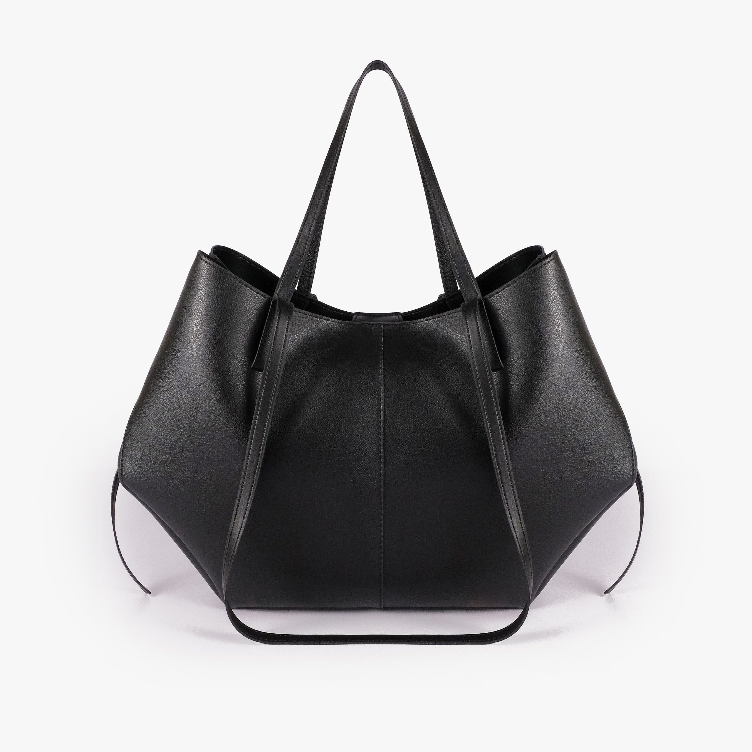Black atelier tote — back view alone showing wing-cut origami panels and slim handles