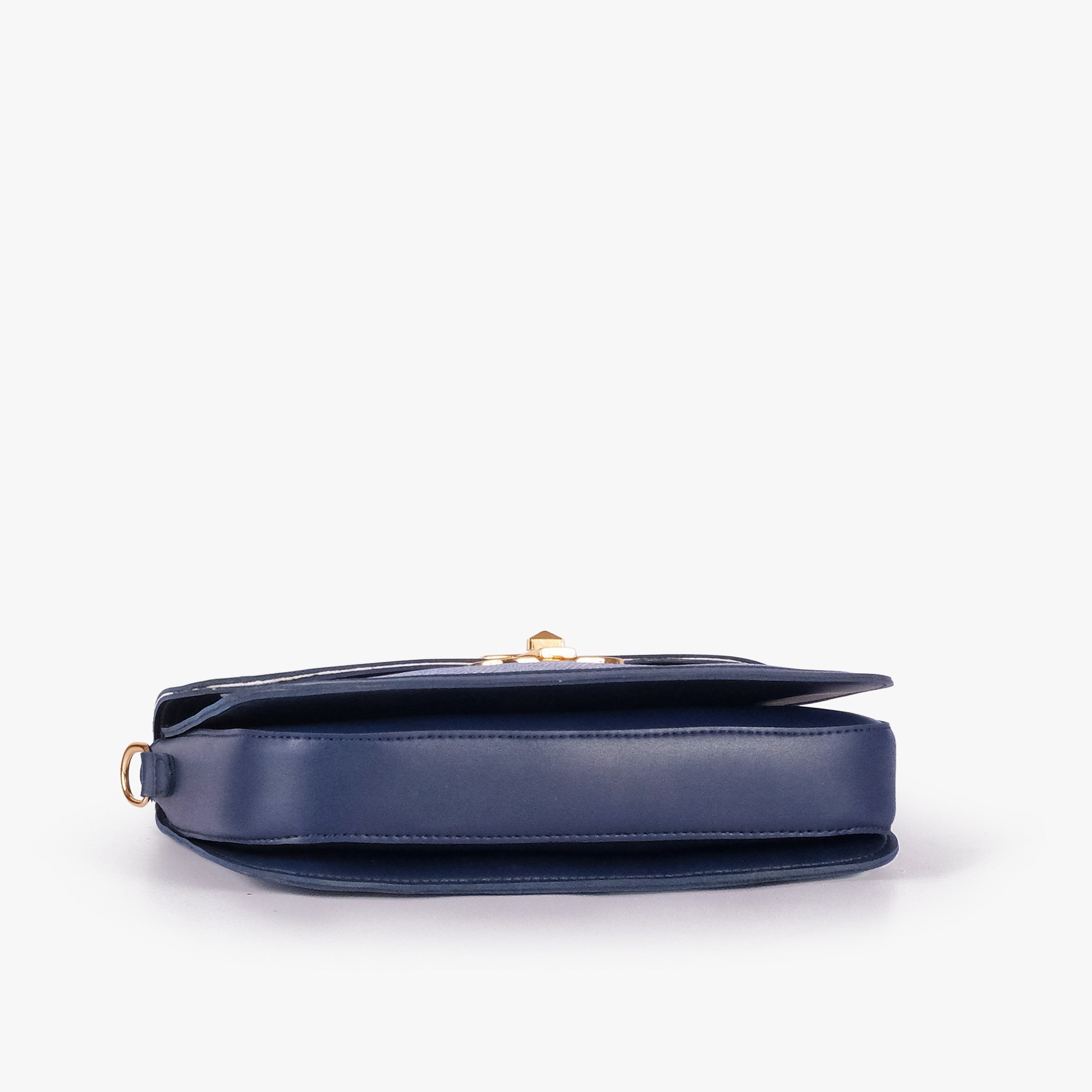 Navy contrast cross-body bag — tilted underside flat lay showing flap edge and bag depth