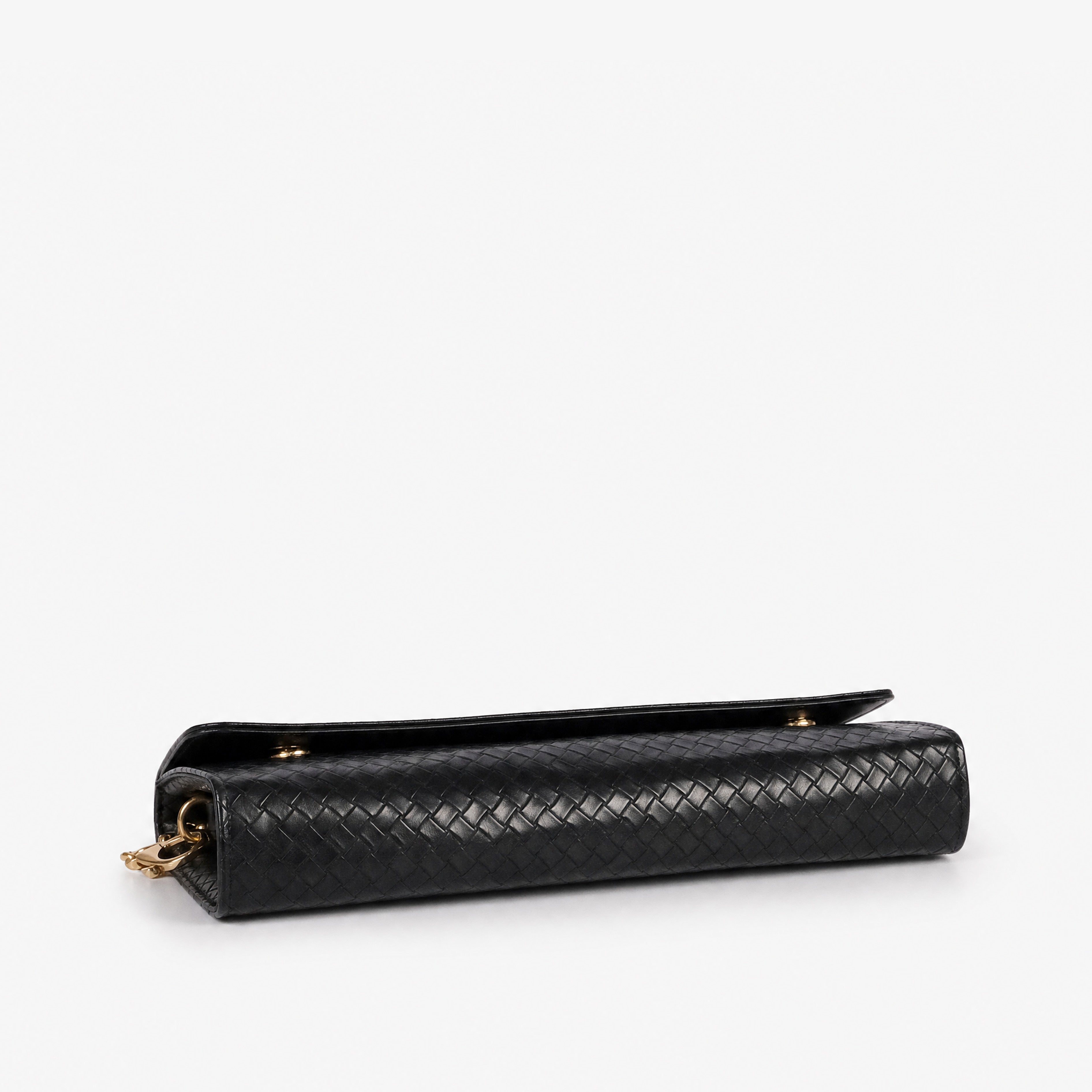 Woven black weave clutch — top-down flat view showing flap closure and full weave surface