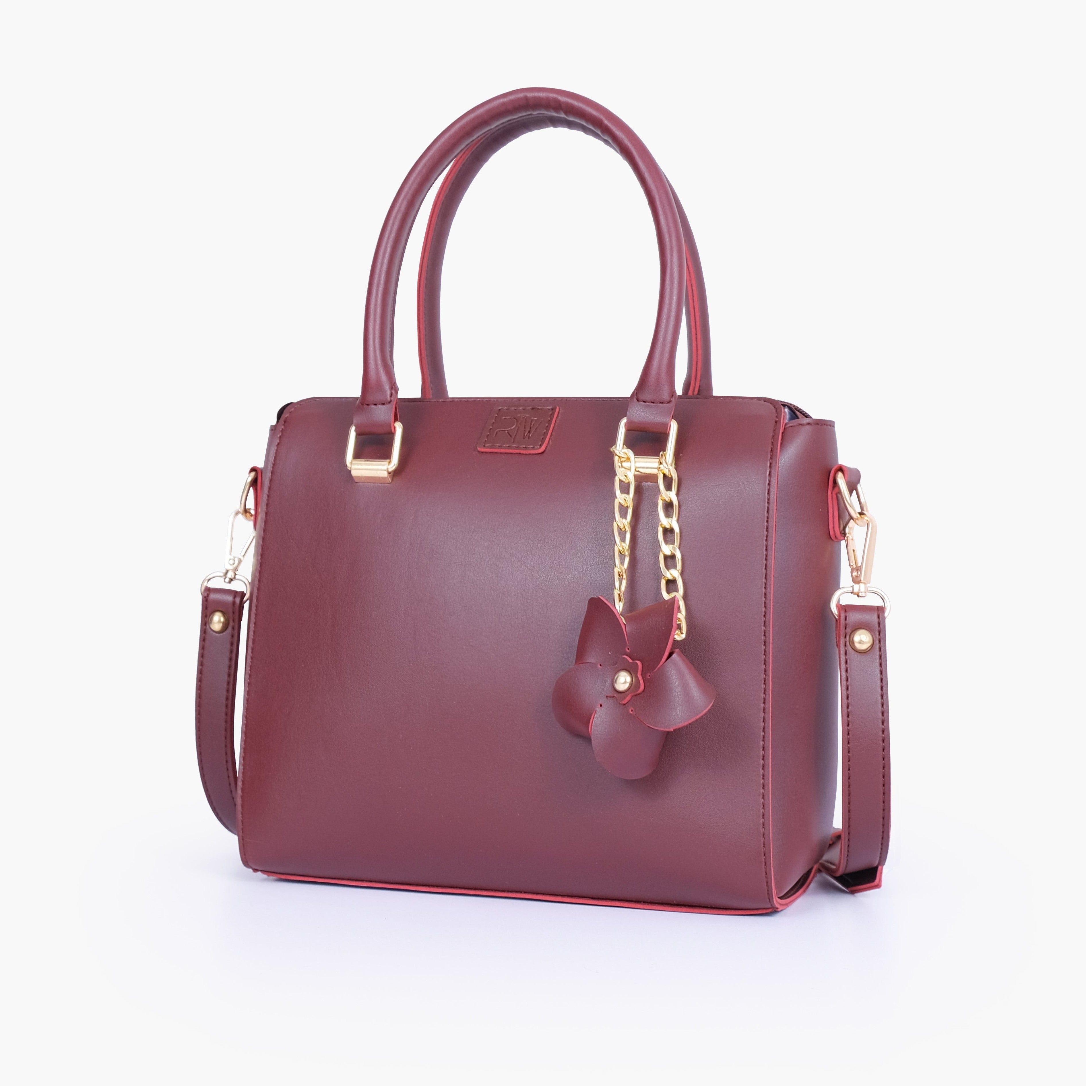 Burgundy handbag with flower charm