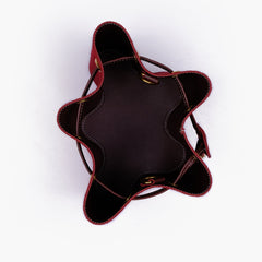 Burgundy suede star drawstring bucket bag
