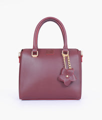 Burgundy handbag with flower charm