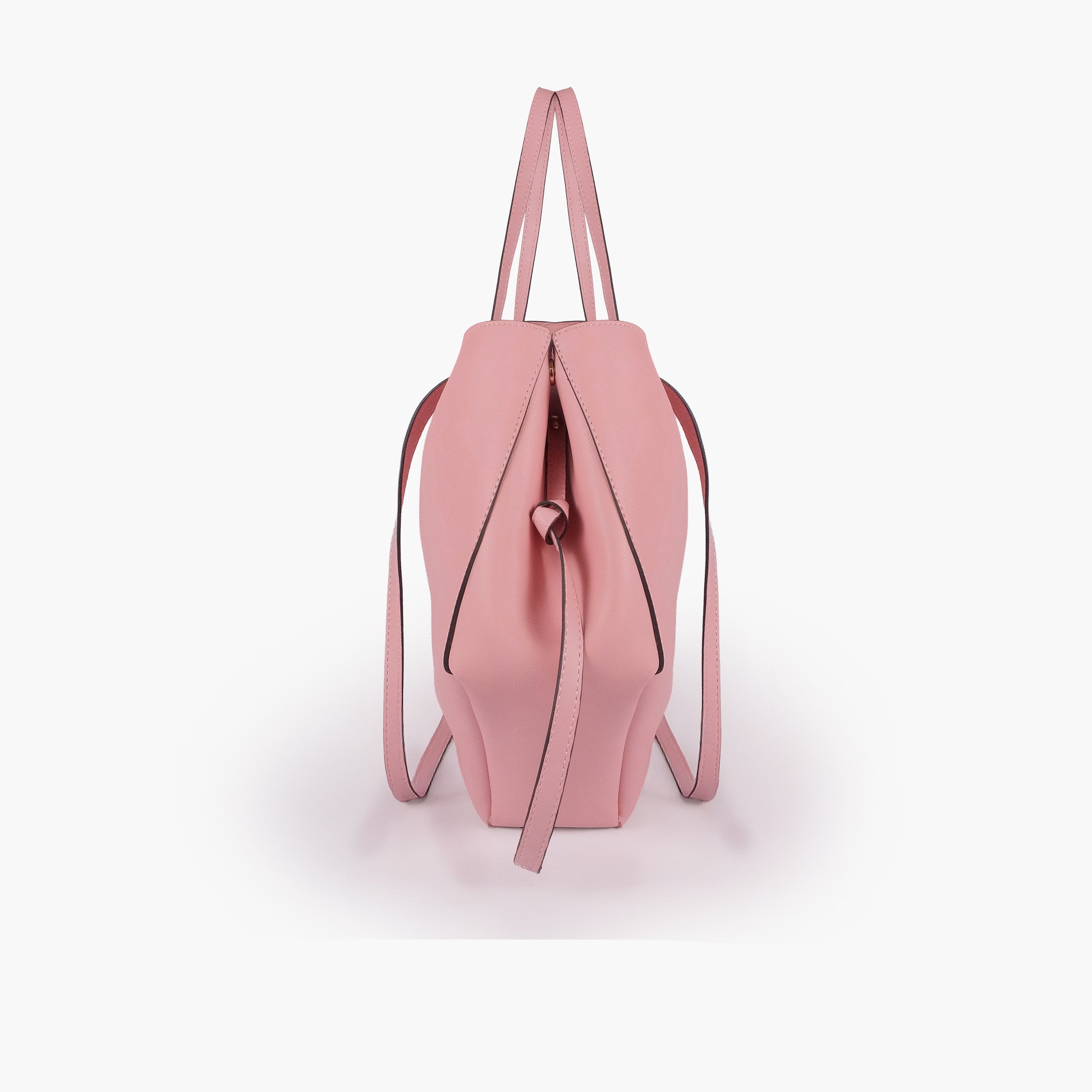 Pink atelier tote — side profile showing wing-cut origami fold, cinch tie, and slim shoulder handle