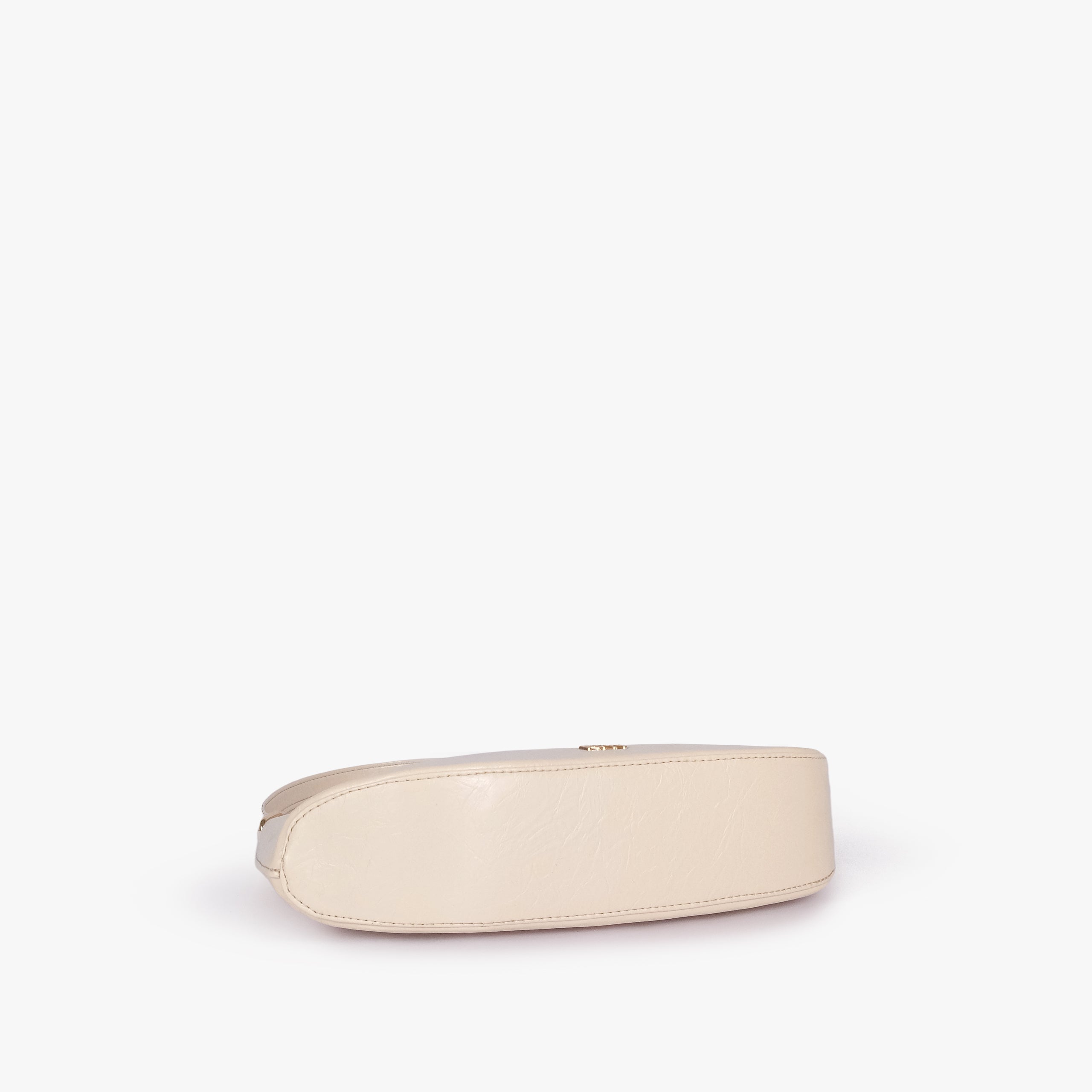 Pearl crinkle shoulder bag — base view showing the matching faux-leather bottom and softly structured shape