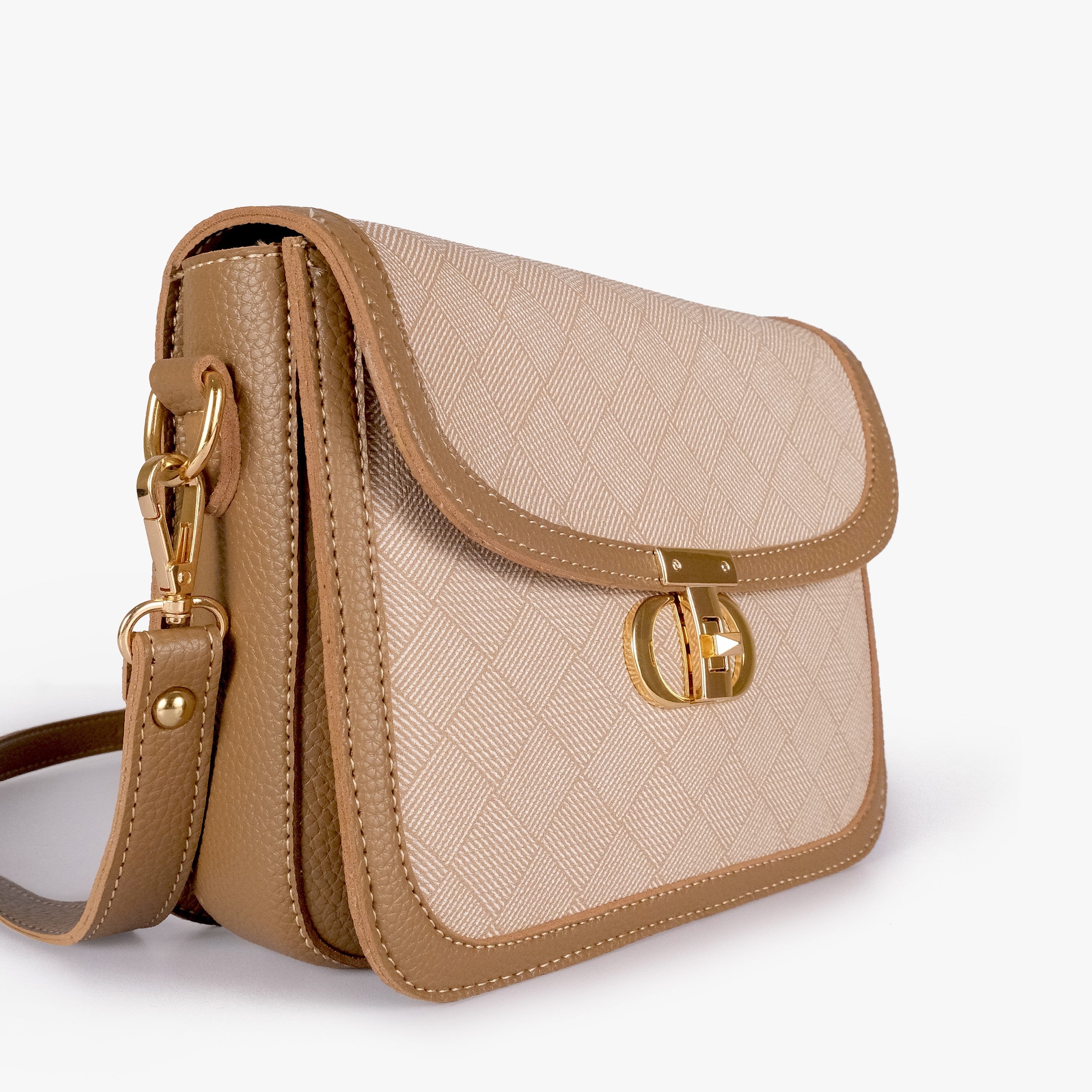 Wheat contrast cross-body bag — closeup of cream crosshatch box-texture panel against camel pebbled trim and gold twist-lock rockstud