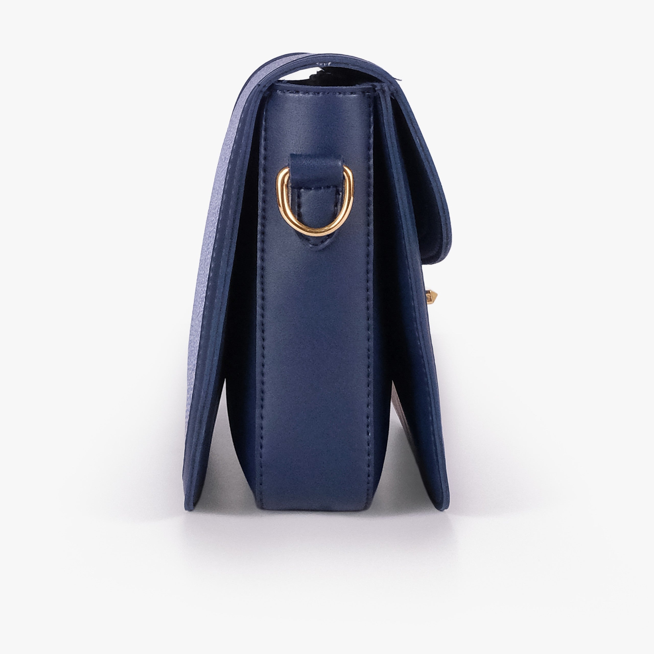 Navy contrast cross-body bag — side profile showing slim gusset and gold D-ring on navy pebbled trim