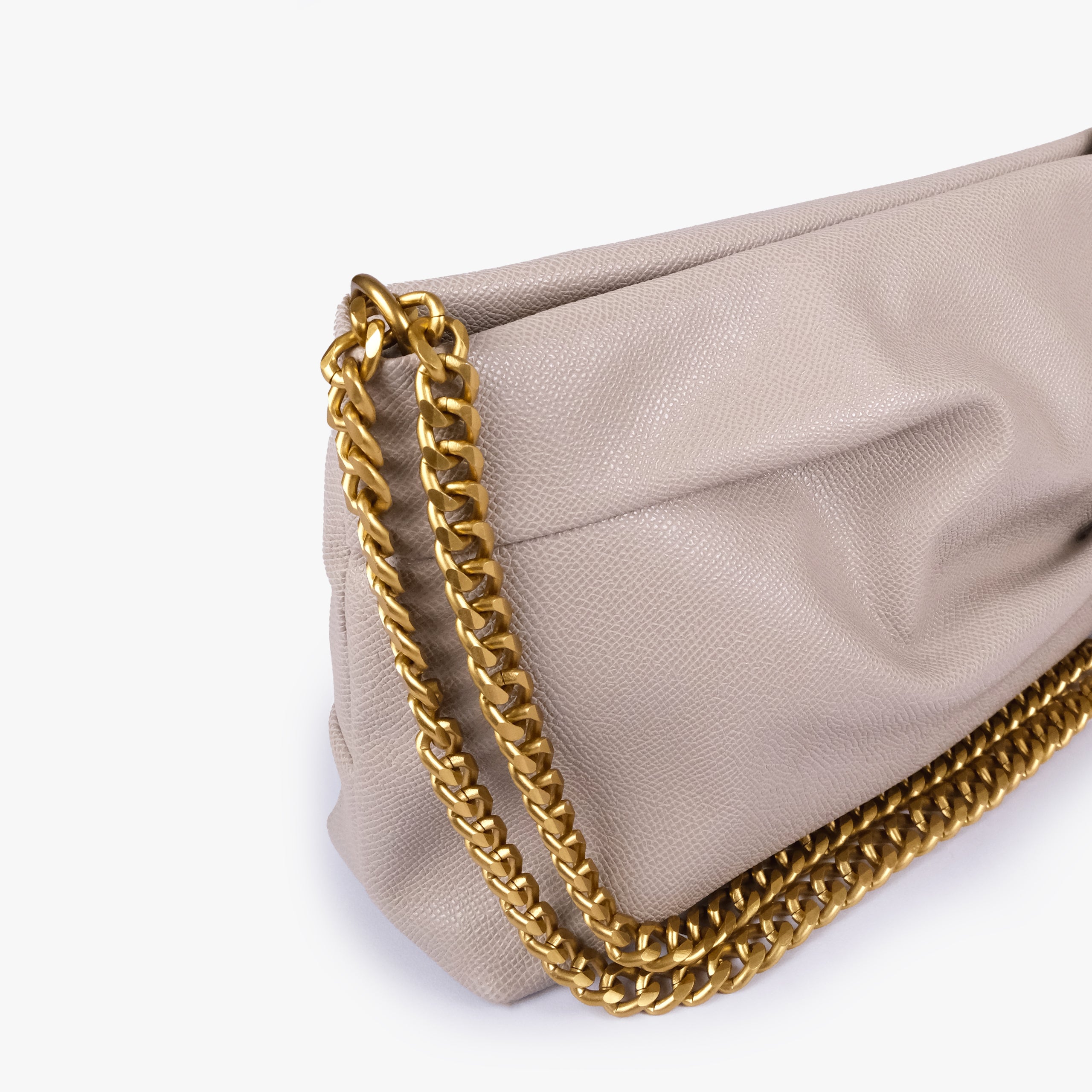 Taupe pleated clutch bag with chain — close detail showing the pleated faux-leather surface, chain links and top-corner hardware, pale gray-beige taupe
