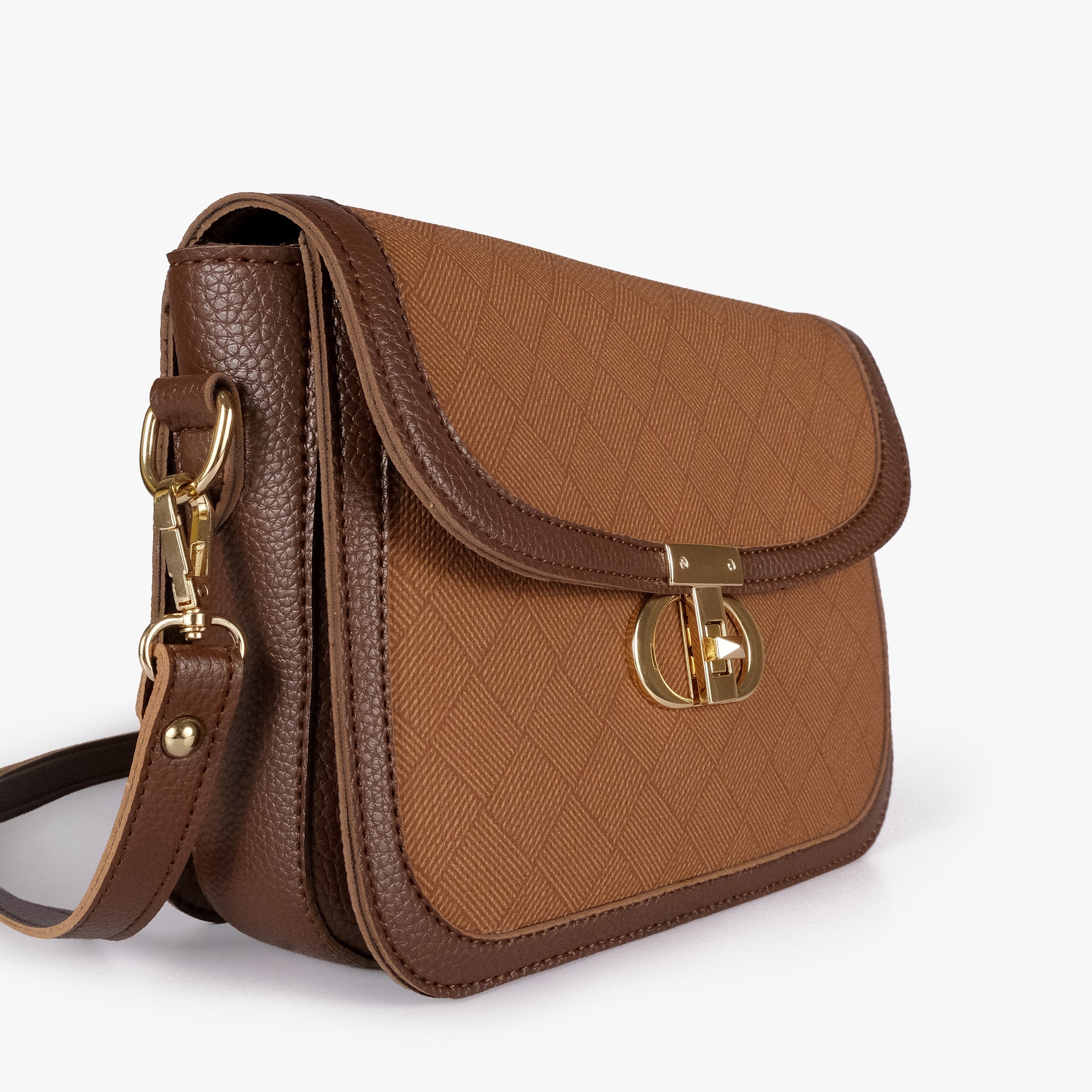Tan contrast cross-body bag — closeup of warm amber crosshatch box-texture panel, chocolate pebbled trim border, and gold twist-lock rockstud