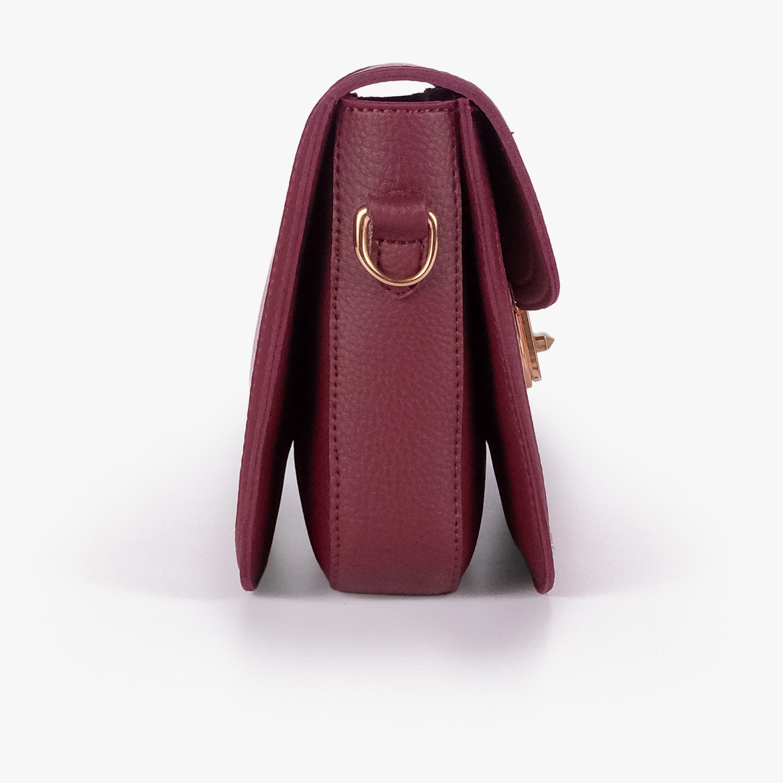 Pink contrast cross-body bag — side profile showing slim gusset and gold D-ring on burgundy trim