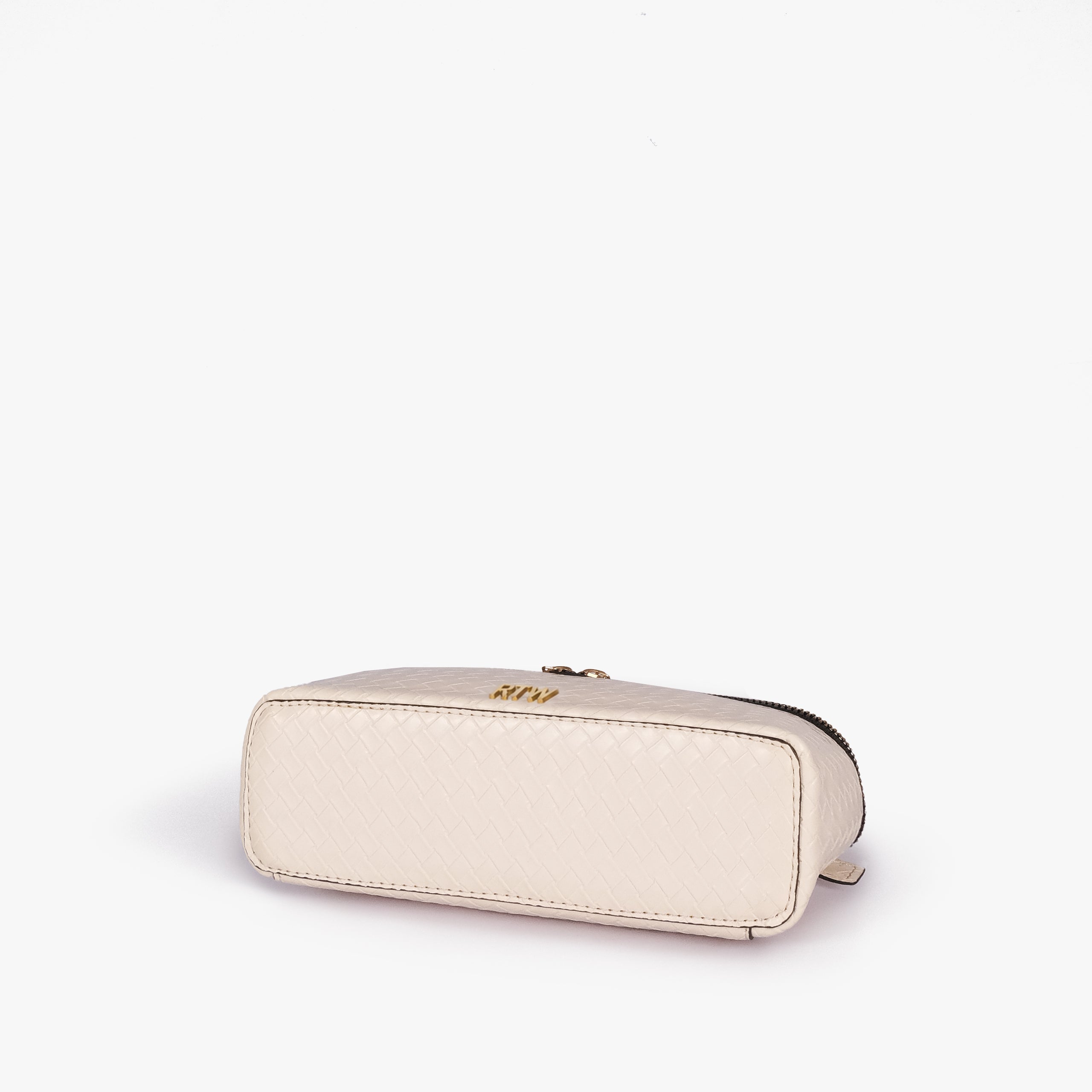 Cream weave vanity top-handle bag — base angle showing the elongated flat rectangular bottom with rounded corners and continuous diamond quilting