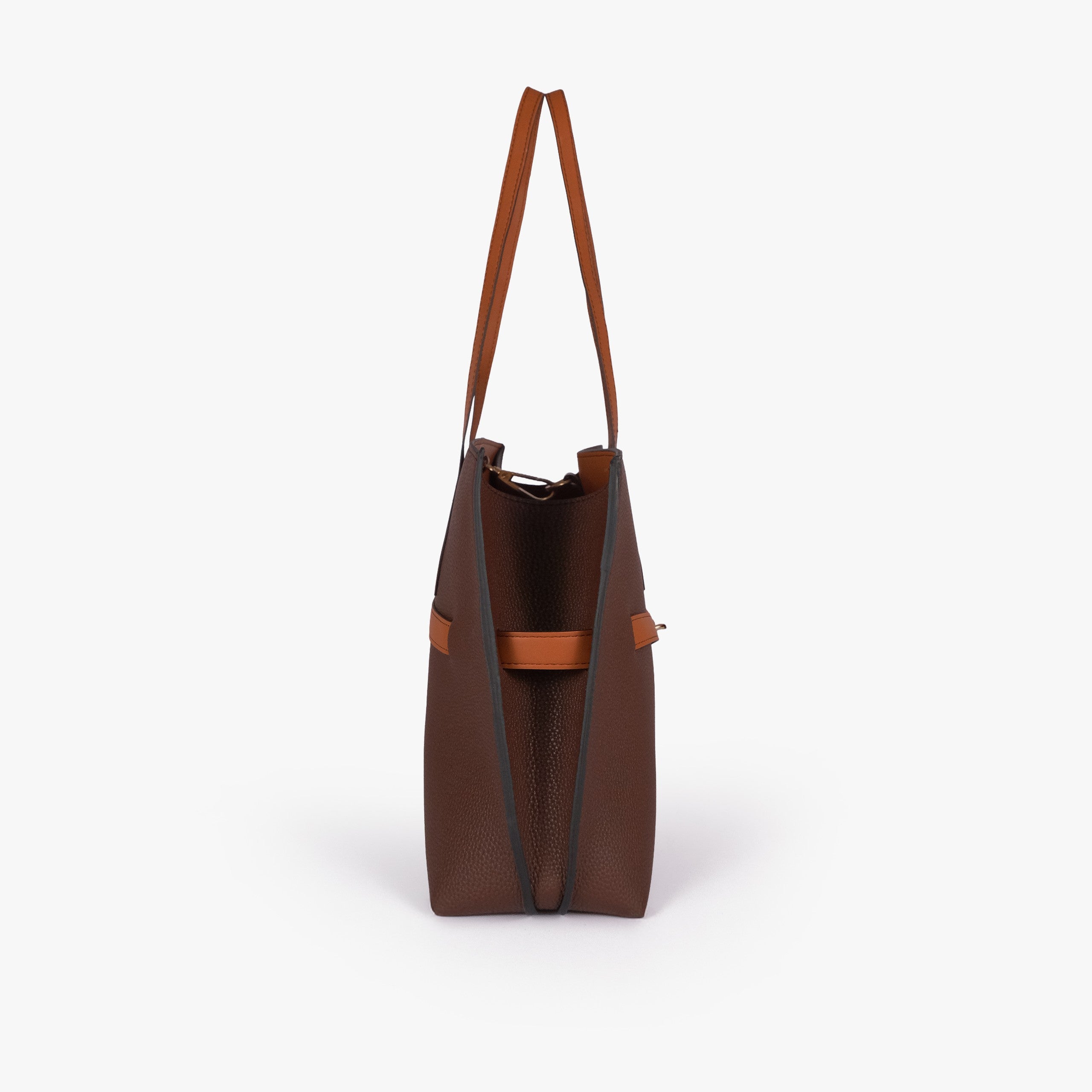 Dark brown Monday Tote — side profile showing slim gusset and wing-cut origami corner fold with cognac accent edging