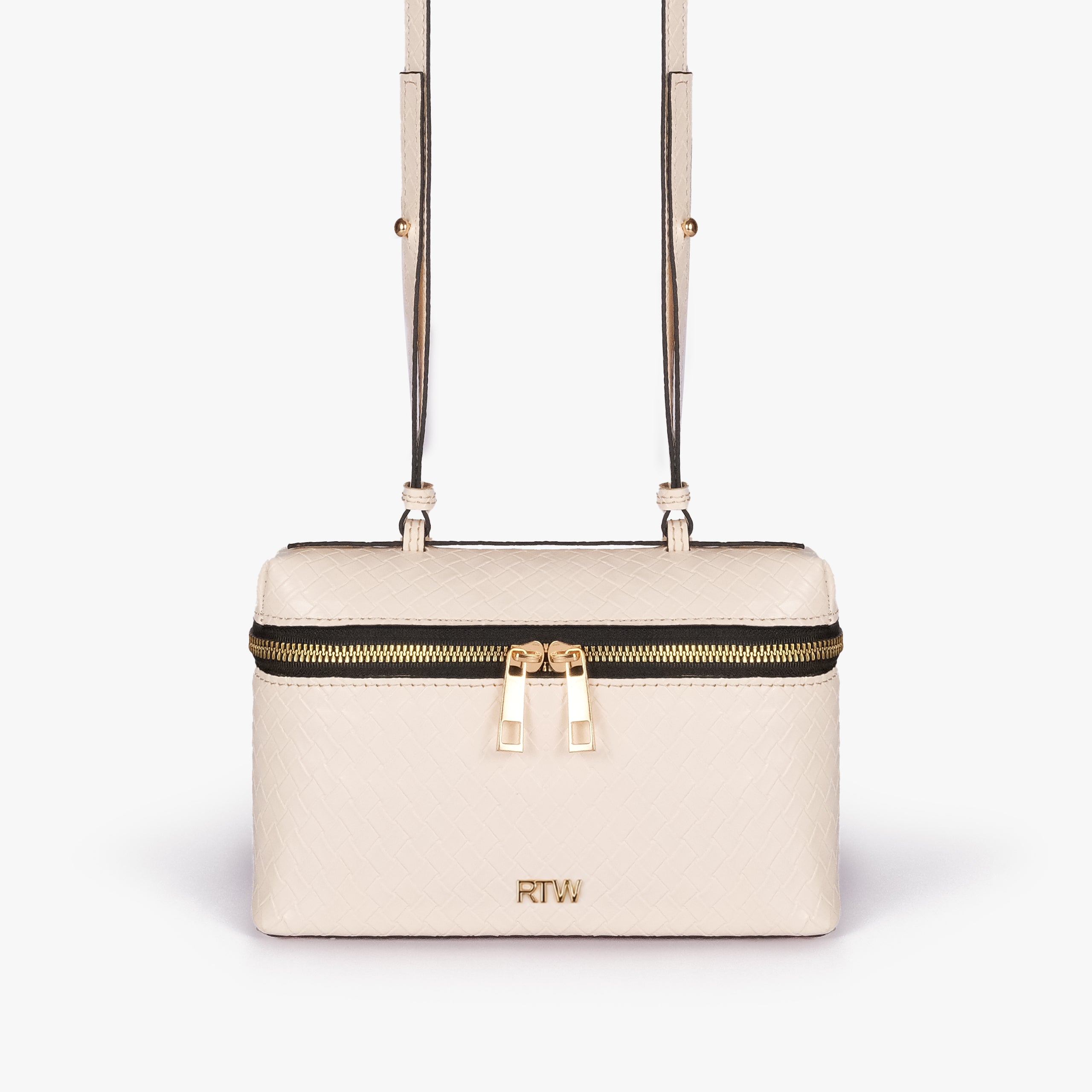 Cream weave vanity top-handle bag — front straight-on view showing the diamond-quilted vanity body, short top handle, long strap, wraparound zipper, and small front logo mark