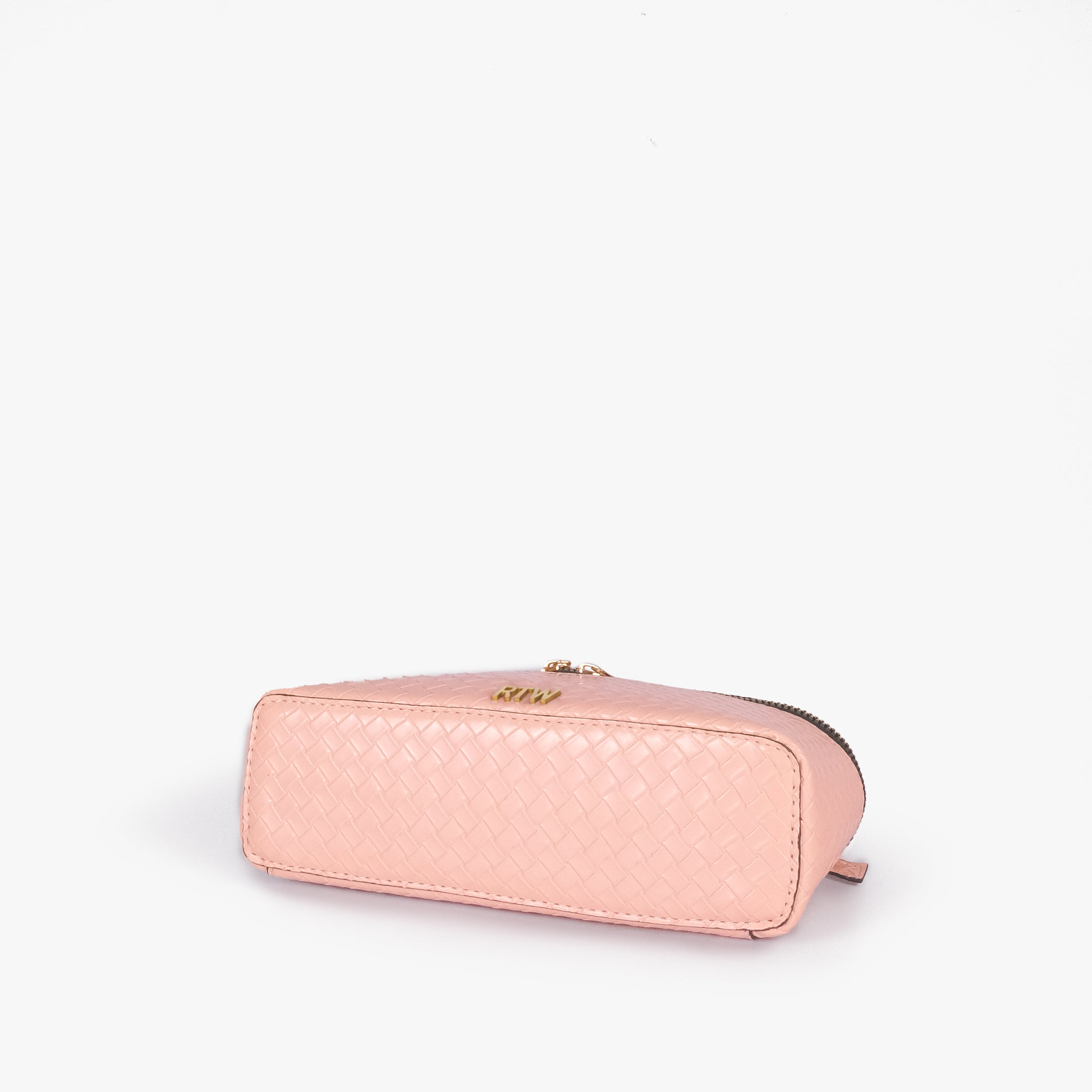 Peach weave vanity top-handle bag — base angle showing the elongated flat rectangular bottom with rounded corners and continuous diamond quilting