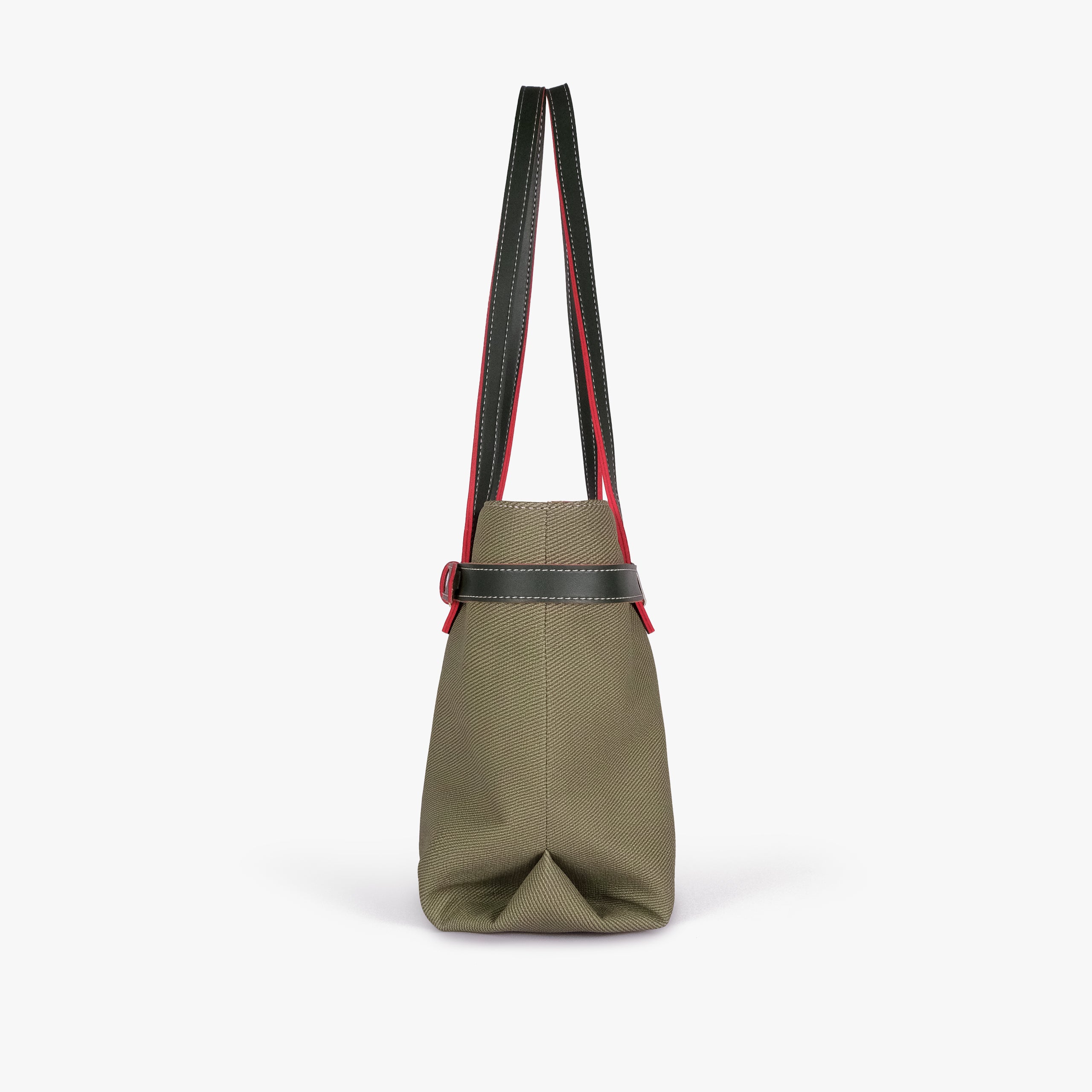 Olive belted tote bag — side profile showing the slim depth, folded side gusset, smooth trim edge, and long shoulder handle drop, olive green textured body with dark smooth faux-leather trim with red accent edging