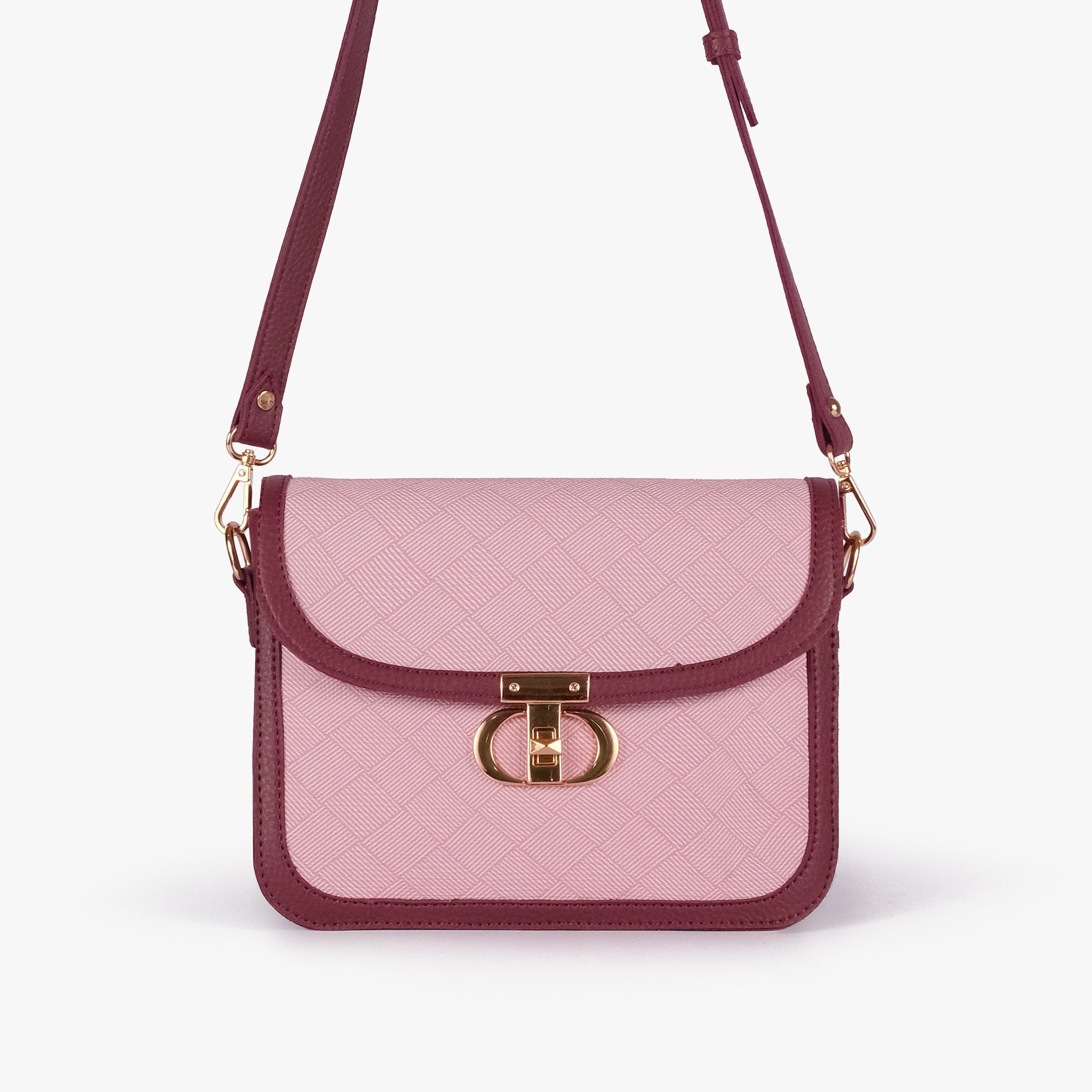 Pink contrast cross-body bag — front view with burgundy strap overhead, cross-body carry position