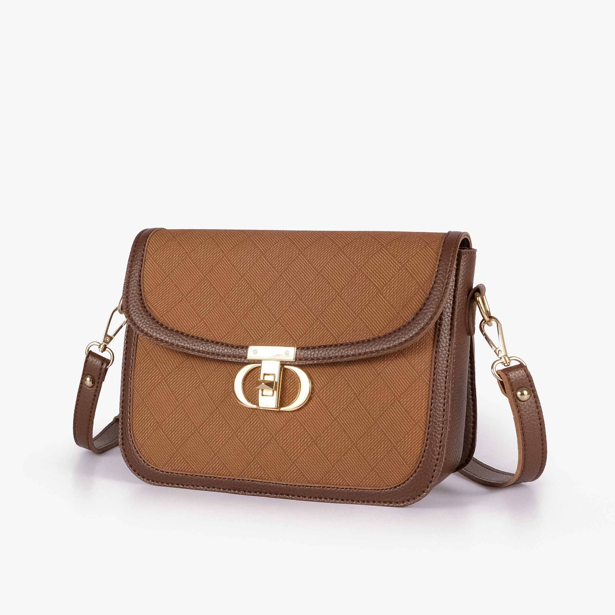 Tan contrast cross-body bag — hero 3/4 view, warm amber box-texture panel, deep chocolate pebbled trim, gold CD twist-lock rockstud and strap