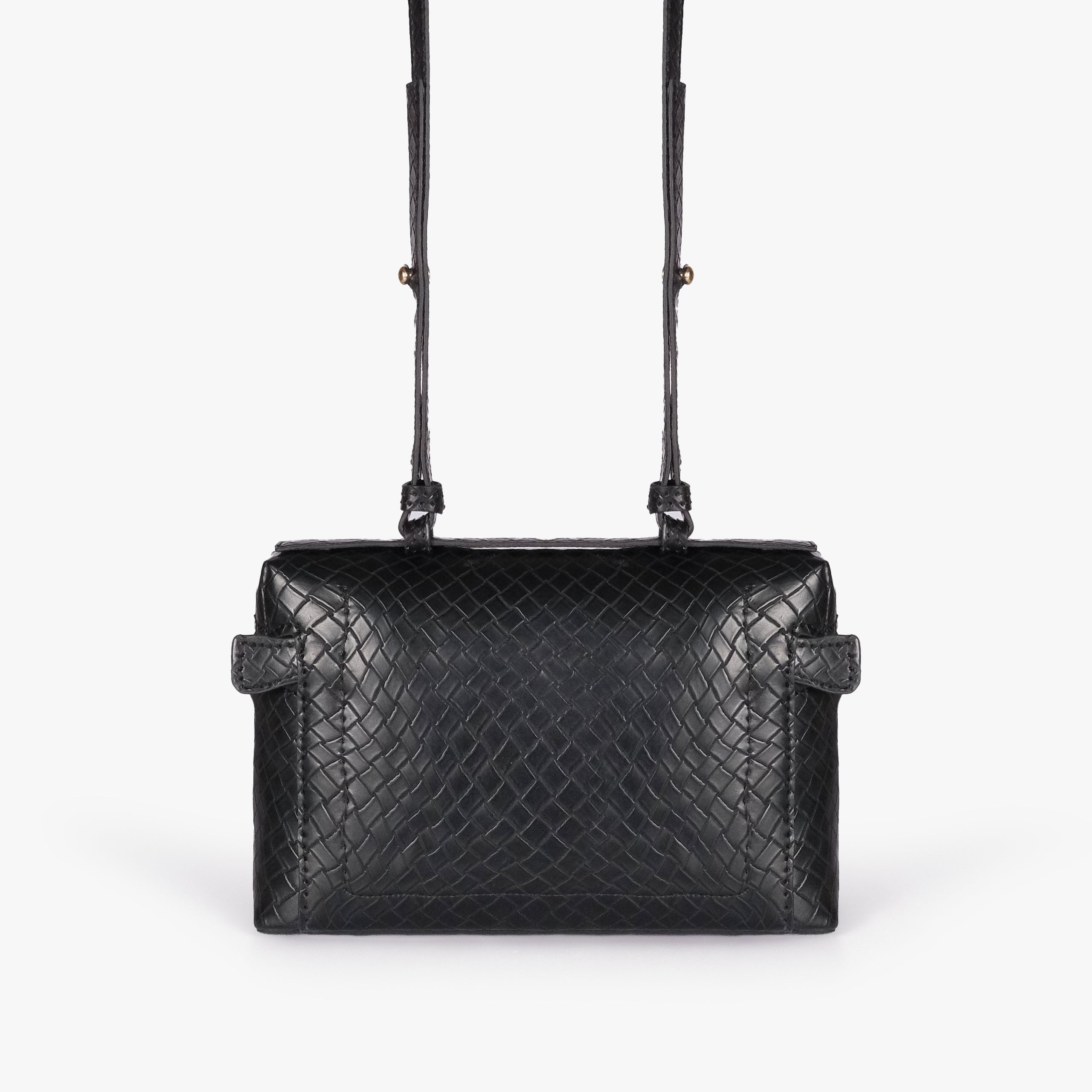 Black weave vanity top-handle bag — back view showing the plain quilted back panel, top handle, long strap, flat base line, and no visible exterior pocket