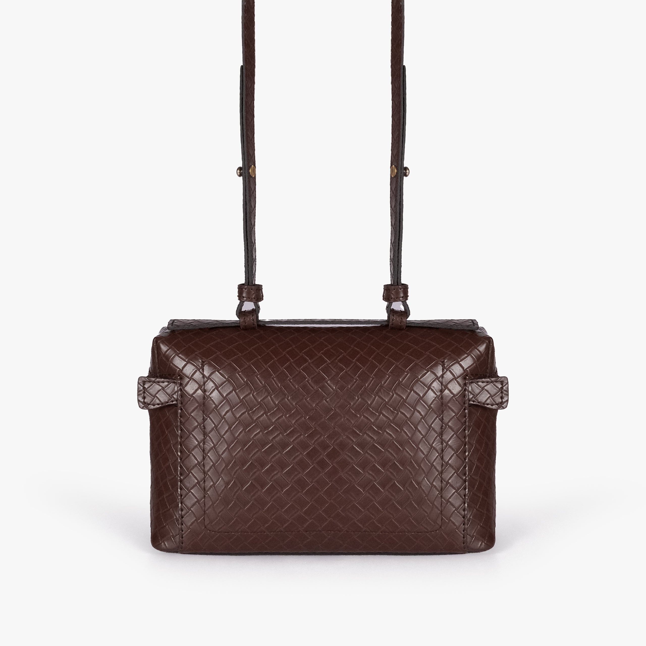 Chocolate brown weave vanity top-handle bag — back view showing the plain quilted back panel, top handle, long strap, flat base line, and no visible exterior pocket
