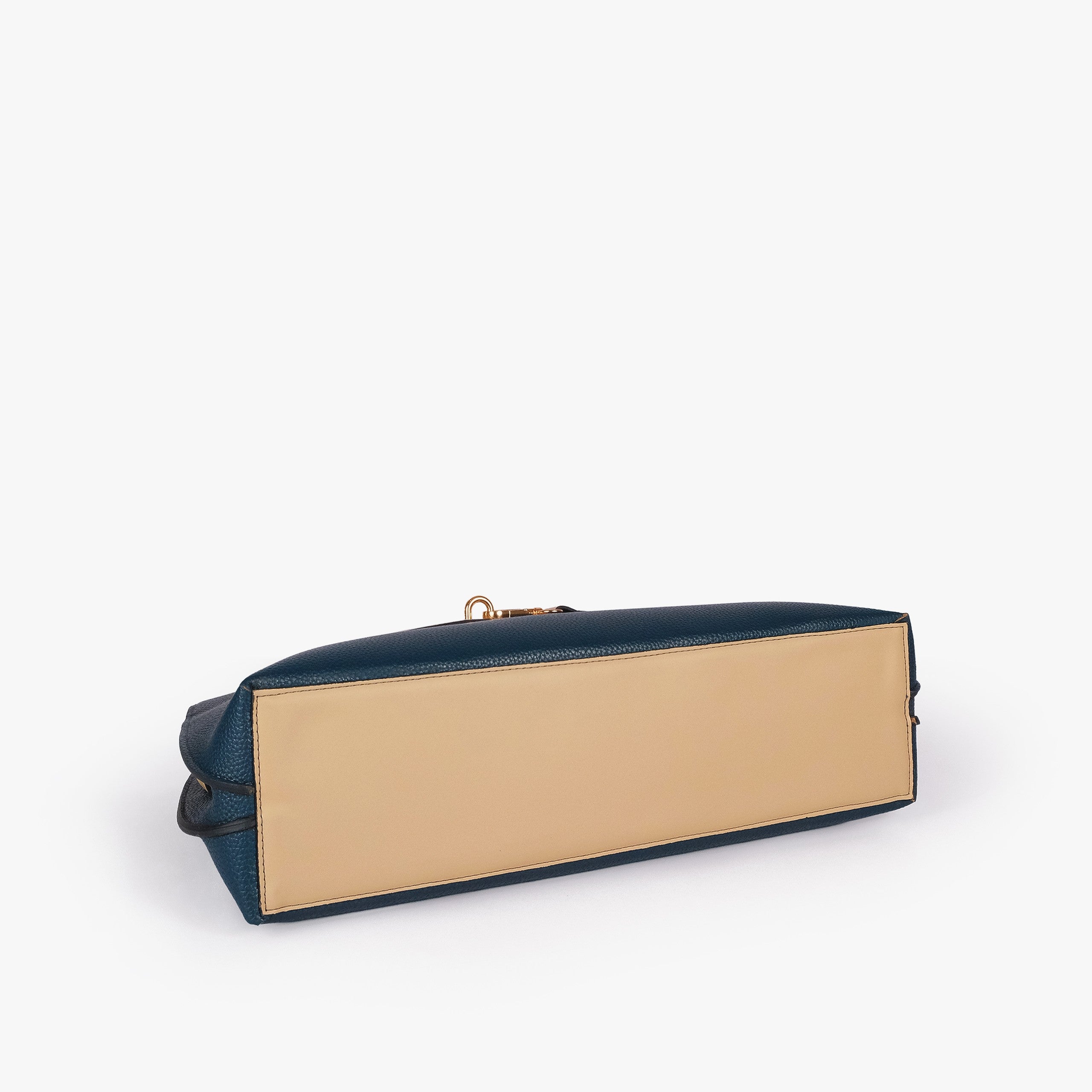 Teal Monday Tote — underside tilted view showing reinforced cream smooth base panel and deep teal pebbled sides